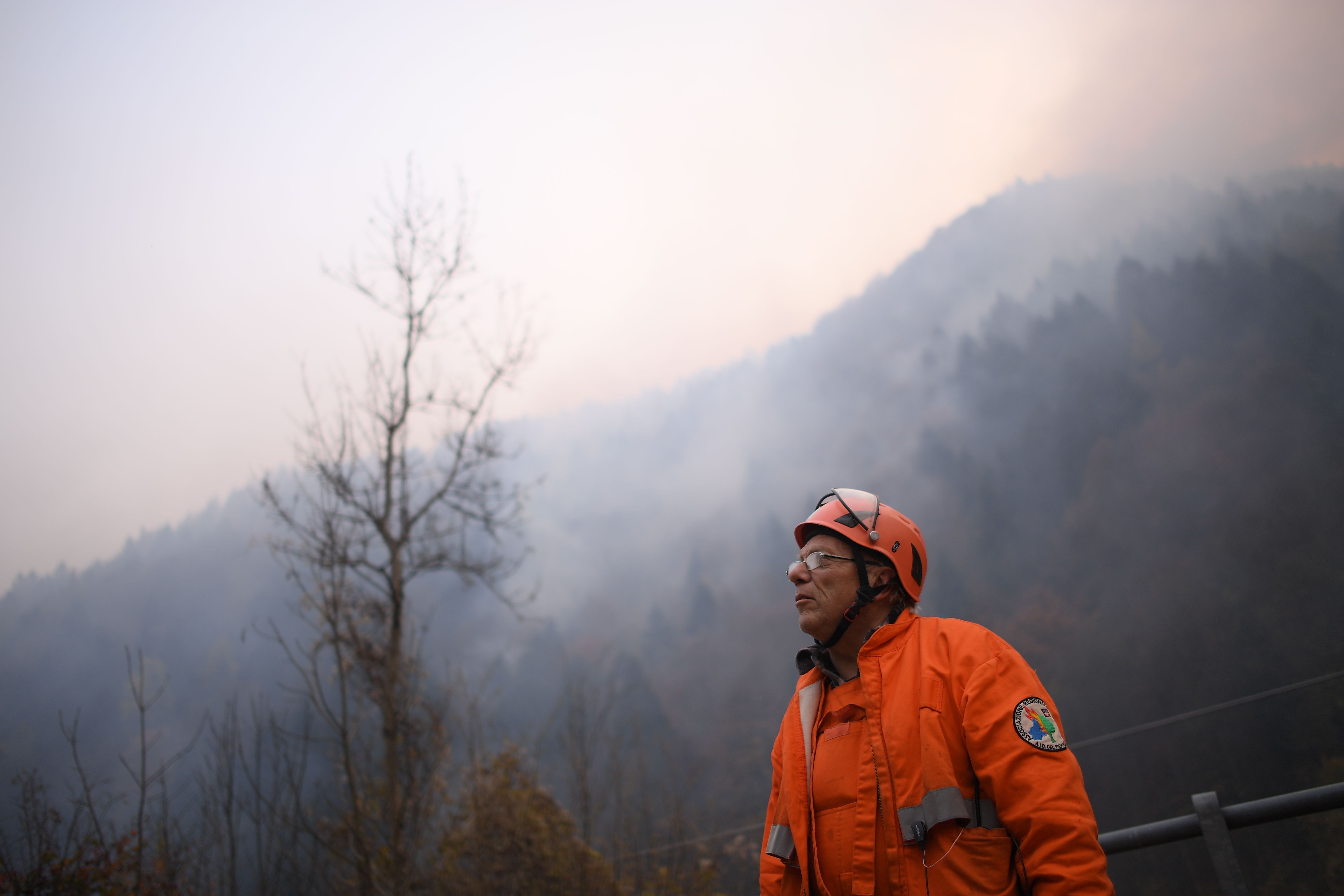 A firefighter volunteer looks at a wildfire near Ribordone, northern Turin, on October 30, 2017. (MARCO BERTORELLO/AFP/Getty Images)