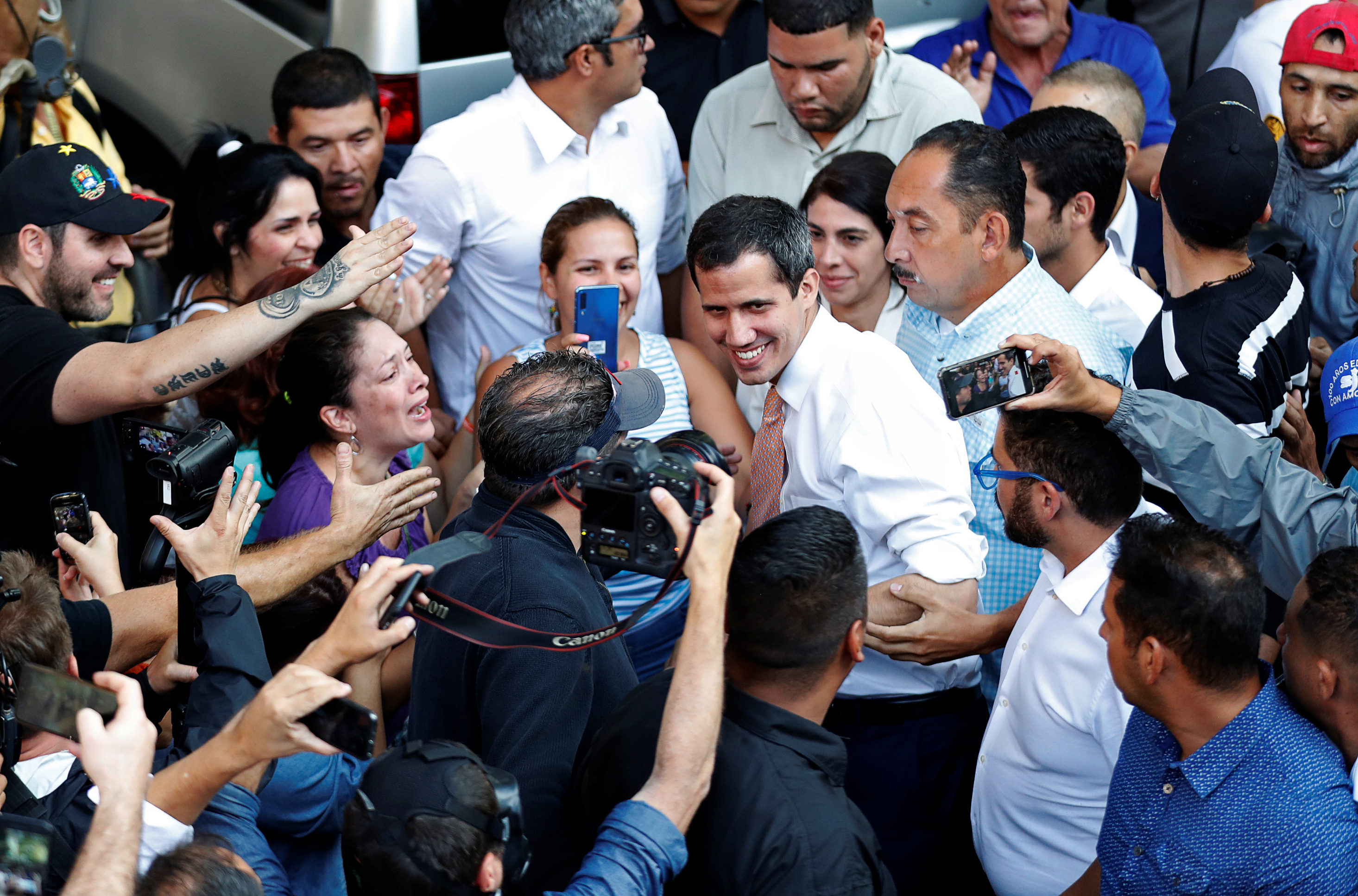 Venezuelan opposition leader Juan Guaido, who many nations have recognised as the country's rightful interim ruler, greets supporters during a gathering in Caracas, Venezuela April 1, 2019. REUTERS/Carlos Garcia Rawlins