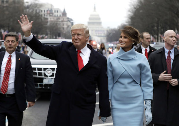 U.S. President Donald Trump waves to supporters as he walks the parade route with first lady Melania Trump after being sworn in at the 58th Presidential Inauguration January 20, 2017 in Washington, D.C. Donald J. Trump was sworn in today as the 45th president of the United States (Photo by Evan Vucci - Pool/Getty Images)