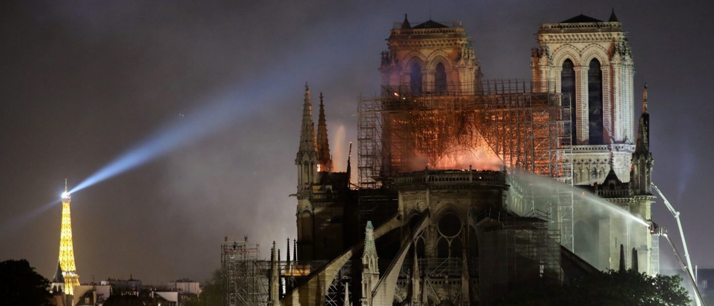 Firefighters douse flames billowing from the roof at Notre-Dame Cathedral in Paris on April 15, 2019. (LUDOVIC MARIN/AFP/Getty Images)