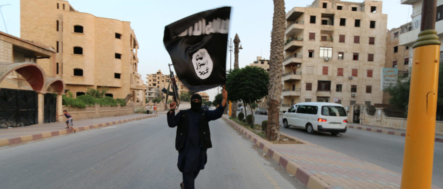 A member loyal to the Islamic State in Iraq and the Levant (ISIL) waves an ISIL flag in Raqqa June 29, 2014. The offshoot of al Qaeda which has captured swathes of territory in Iraq and Syria has declared itself an Islamic "Caliphate" and called on factions worldwide to pledge their allegiance, a statement posted on jihadist websites said on Sunday. The group, previously known as the Islamic State in Iraq and the Levant (ISIL), also known as ISIS, has renamed itself "Islamic State" and proclaimed its leader Abu Bakr al-Baghadi as "Caliph" - the head of the state, the statement said. REUTERS/Stringer