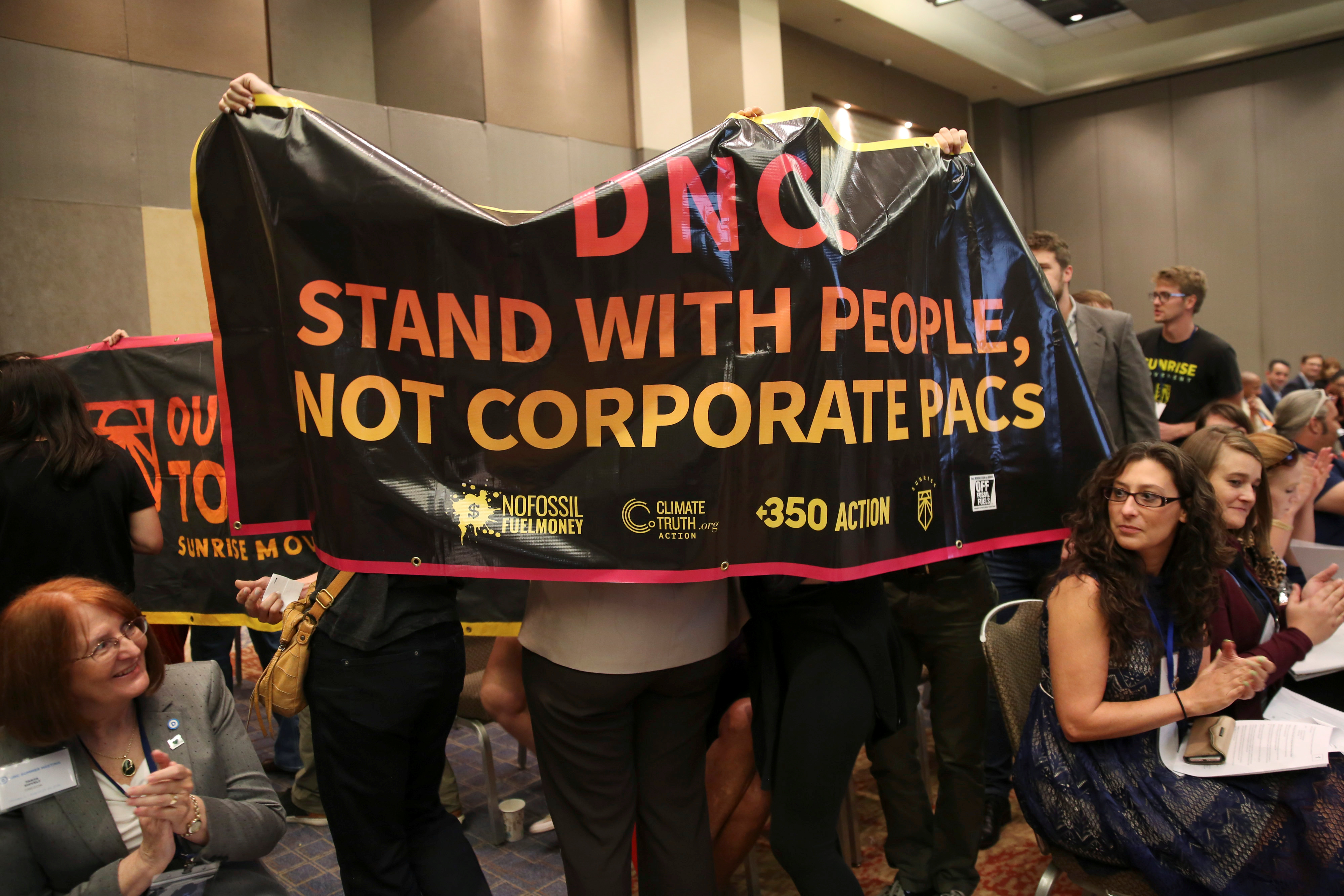 Demonstrators interrupt the DNC Summer Meeting in Chicago