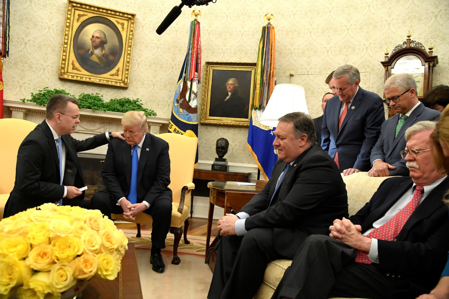 U.S. President Donald Trump closes his eyes in prayer along with Pastor Andrew Brunson, after his release from two years of Turkish detention, along with Secretary of State Mike Pompeo and National Security Advisor John Bolton, in the Oval Office of the White House, Washington, U.S., October 13, 2018. REUTERS/Mike Theiler