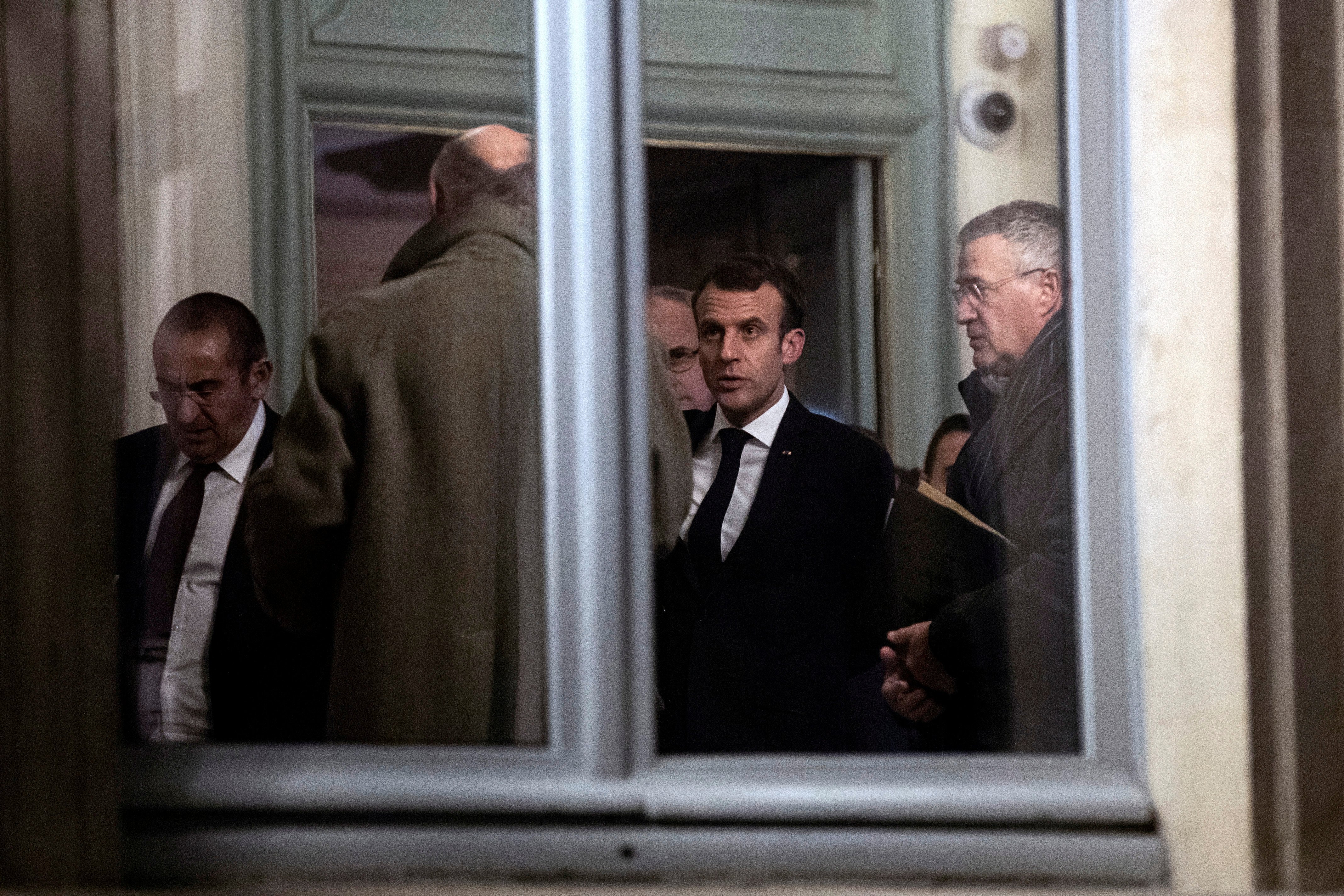 French President Emmanuel Macron (2-R) leaves an emergency meeting at the Interior Ministry in Paris, France, late 11 December 2018. (ETIENNE LAURENT / POOL via REUTERS )