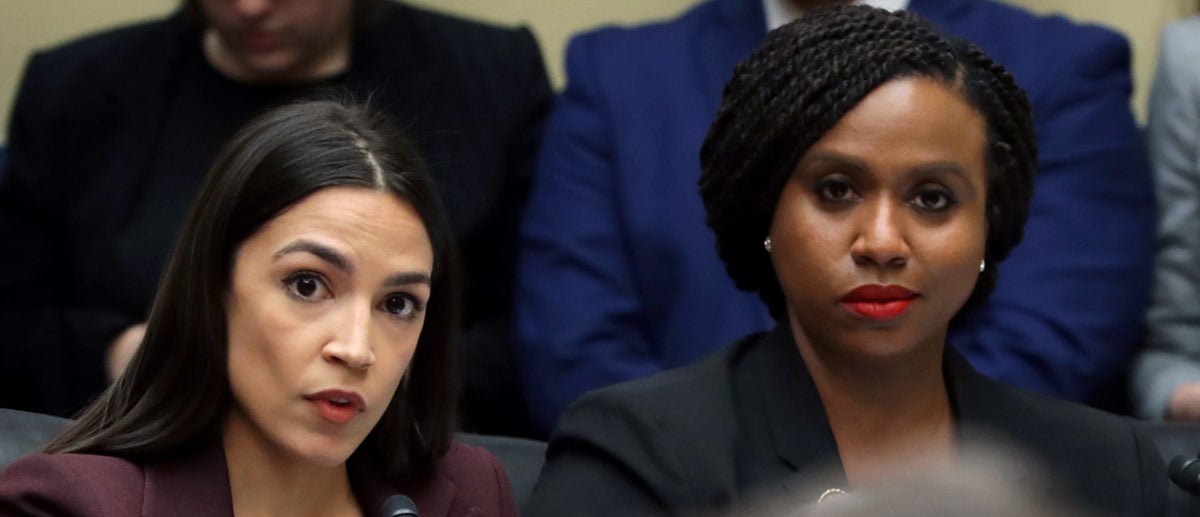 (L-R) Rep. Alexandria Ocasio-Cortez, Rep. Ayanna Pressley and Rep. Rashida Tlaib listen as Michael Cohen, former attorney and fixer for President Donald Trump, testifies before the House Oversight Committee on Capitol Hill February 27, 2019 in Washington, DC. (Photo by Chip Somodevilla/Getty Images)