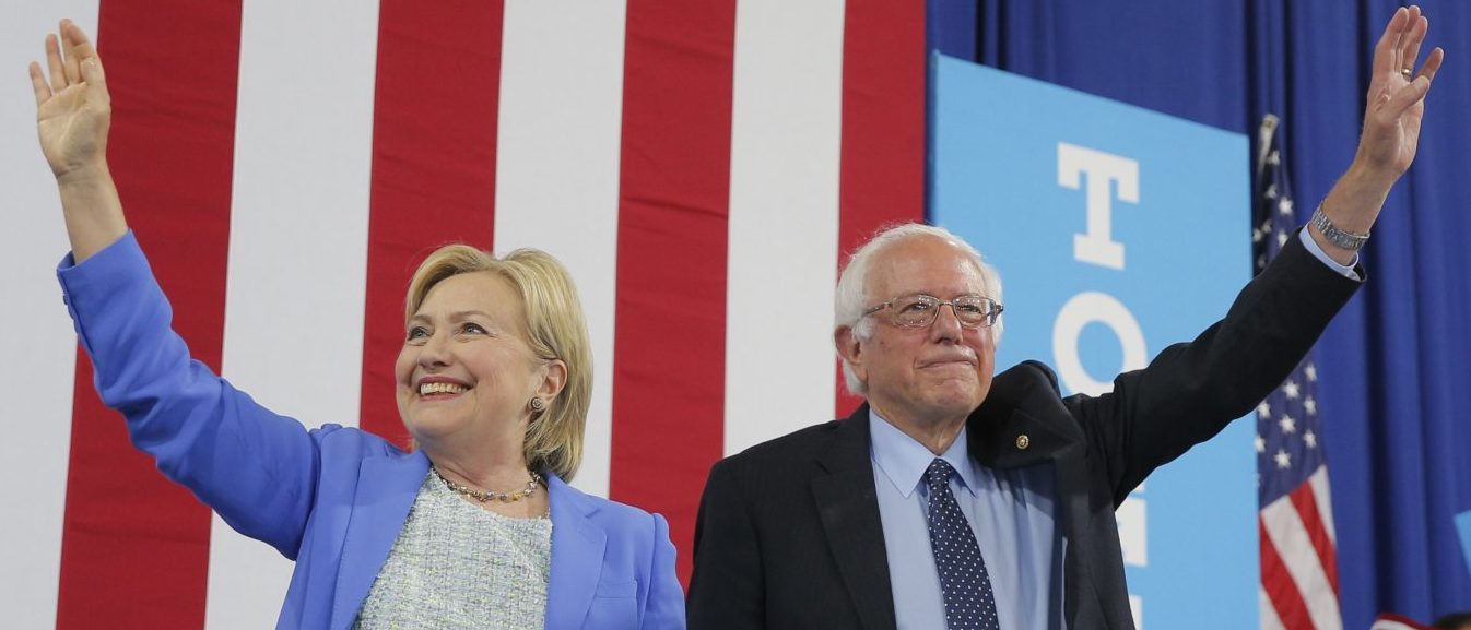 Democratic U.S. presidential candidate Hillary Clinton and Sen. Bernie Sanders stand together during a campaign rally where Sanders endorsed Clinton in Portsmouth, New Hampshire, U.S., July 12, 2016. REUTERS/Brian Snyder