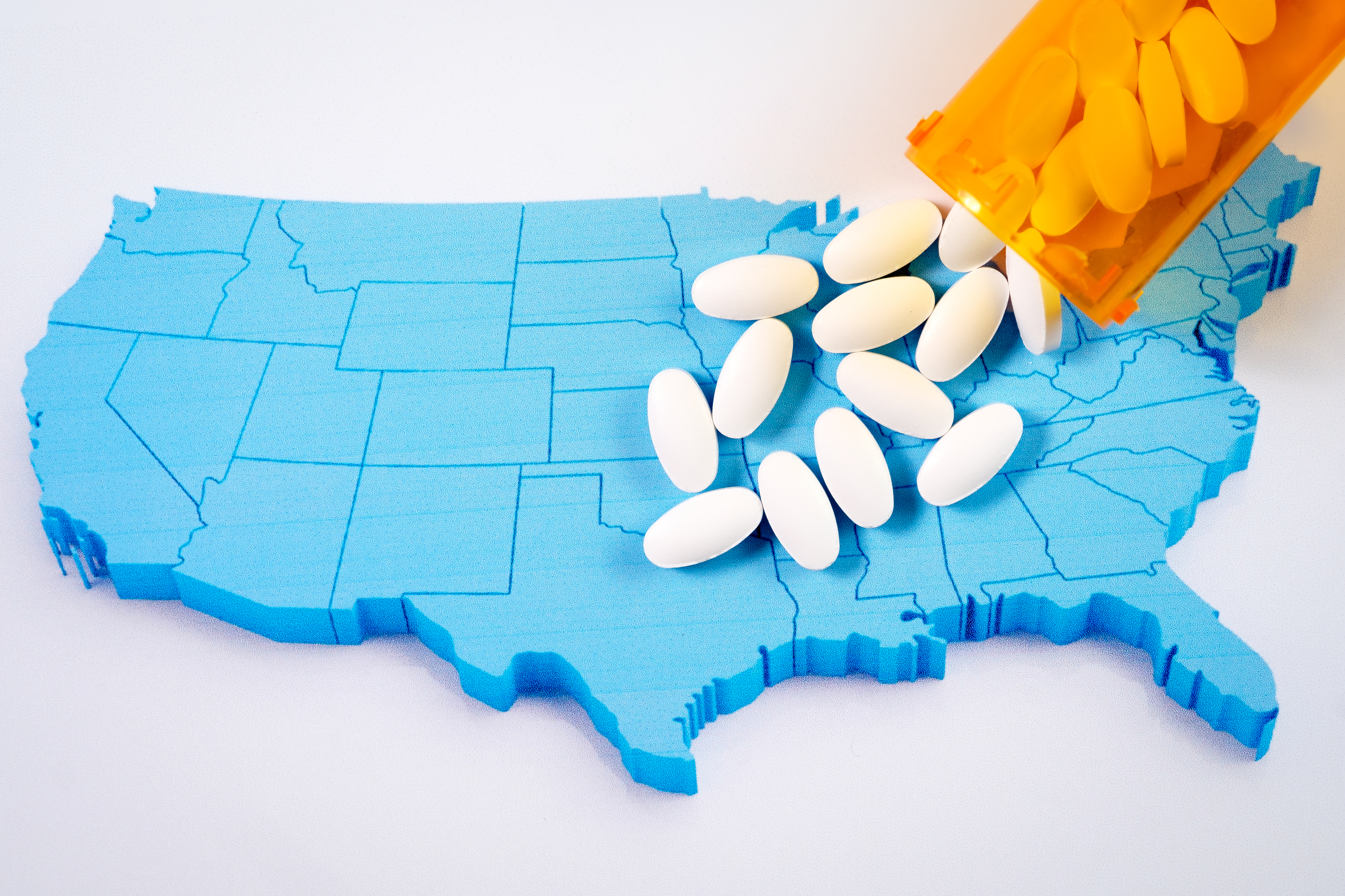 Pills are dumped on a model of the U.S. Shutterstock image via user Scotyard
