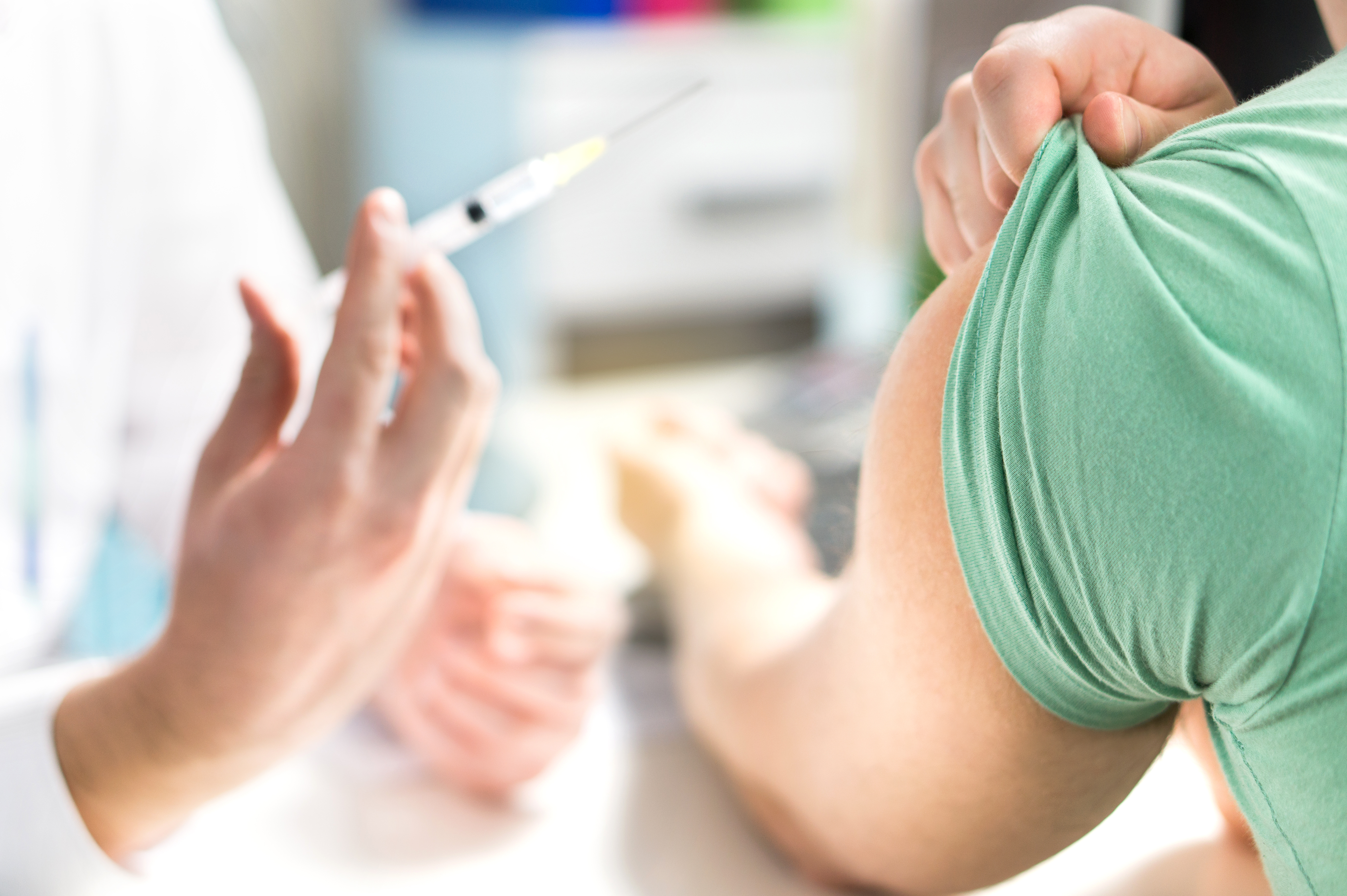 A patient prepares to receive a vaccination. Shutterstock image via Tero Vesalainen