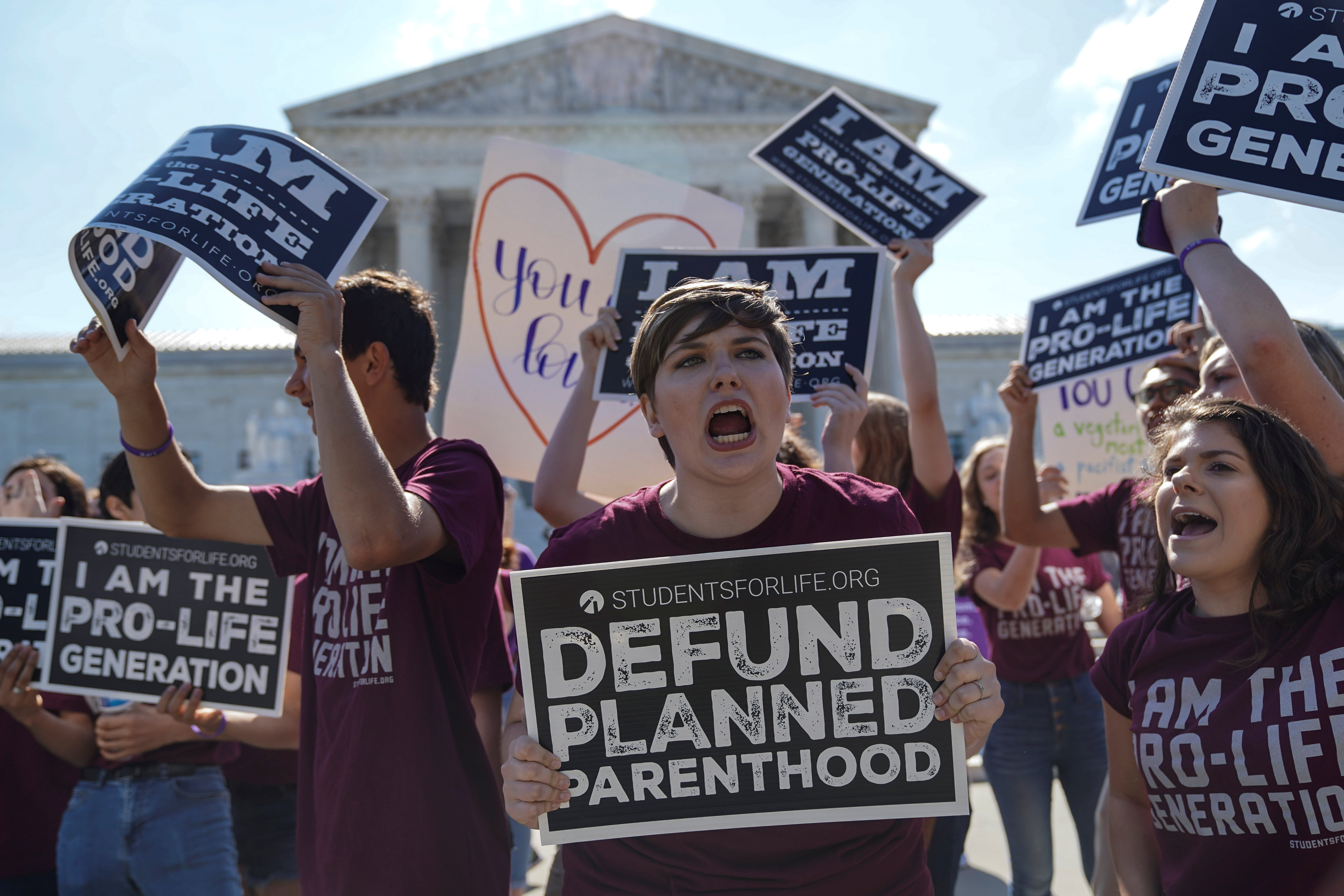 Pro-life and pro-choice protesters rally outside the U.S. Supreme Court waiting for the National Institute of Family and Life Advocates v. Becerra case, which remains pending, in Washington, U.S., June 25, 2018. REUTERS/Toya Sarno Jordan
