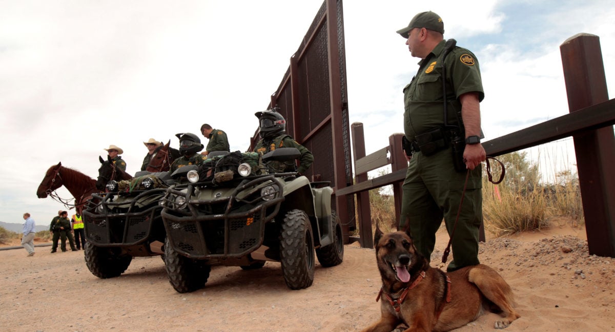 Border Patrol agents keep watch during the official start for the construction of new bollard wall to replace 20-miles of primary vehicle barriers in Santa Teresa