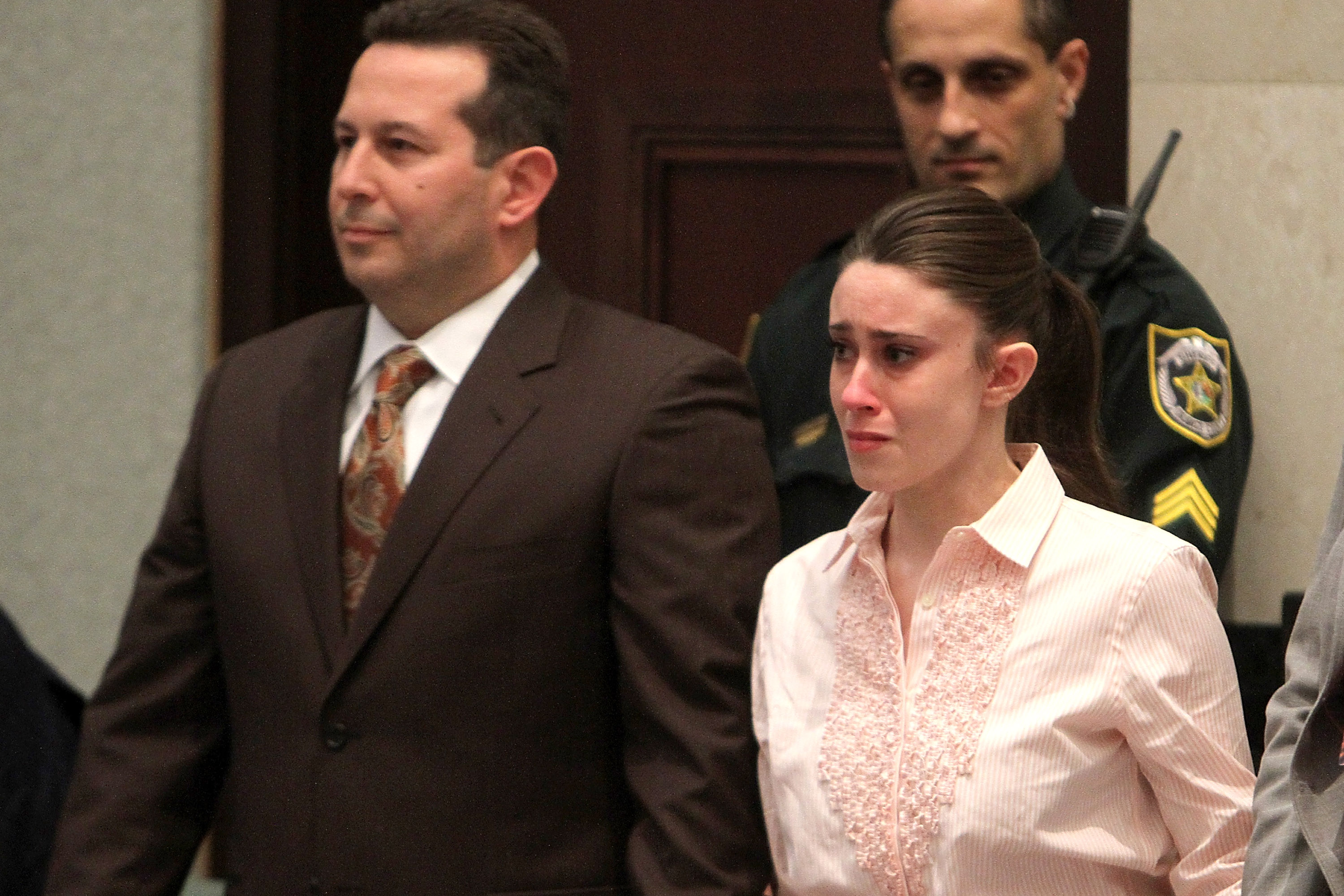 Casey Anthony (R) reacts to being found not guilty on murder charges at the Orange County Courthouse on July 5, 2011 in Orlando, Florida. At left is her attorney Jose Baez. Casey Anthony had been accused of murdering her two-year-old daughter Caylee in 2008. (Photo by Red Huber-Pool/Getty Images)