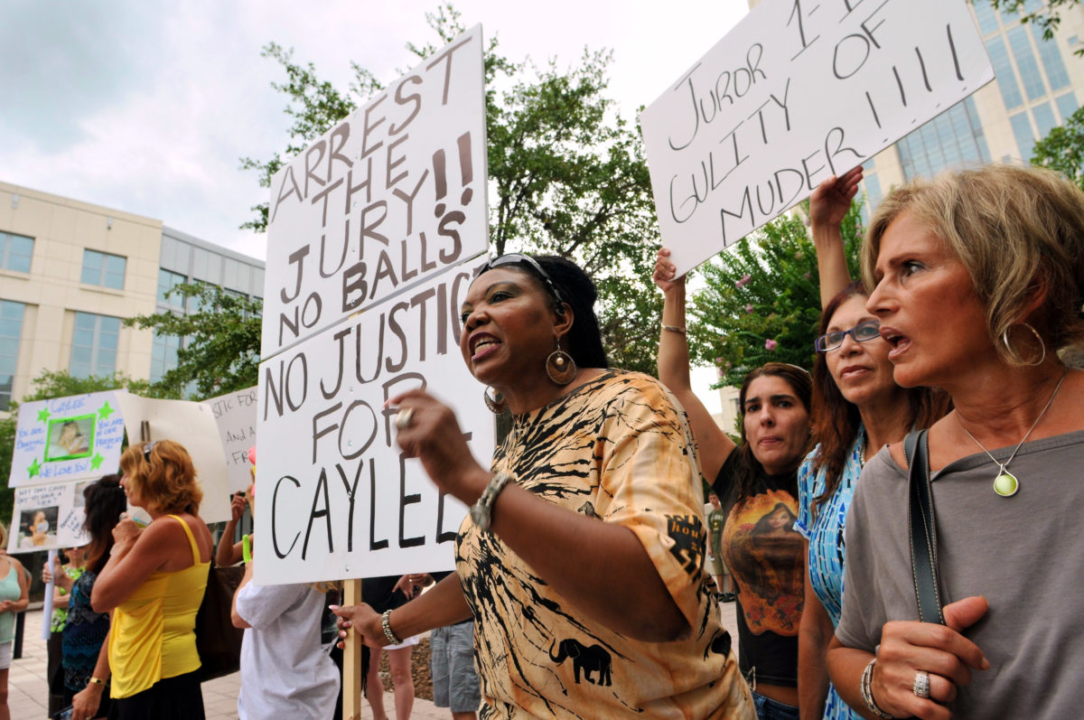Flora Reece (center) of Orlando protests the Casey Anthony verdict outside of the Orange County Courthouse July 7, 2011 in Orlando, Florida. Anthony was acquitted of murder charges on July 5, 2011 but will serve four, one-year sentences on her conviction on July 7 of lying to a law enforcement officer. She will be credited for the nearly three-years of time served and good behavior and will reportedly be released July 13. (Photo by Roberto Gonzalez/Getty Images)