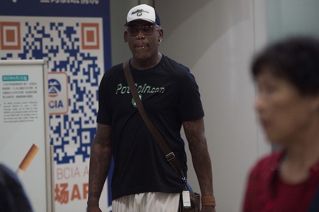 Former NBA basketball player Dennis Rodman (C) of the US walks out from the arrival gate returning from his trip to North Korea at Beijing's international airport on June 17, 2017. (Photo credit: NICOLAS ASFOURI/AFP/Getty Images)