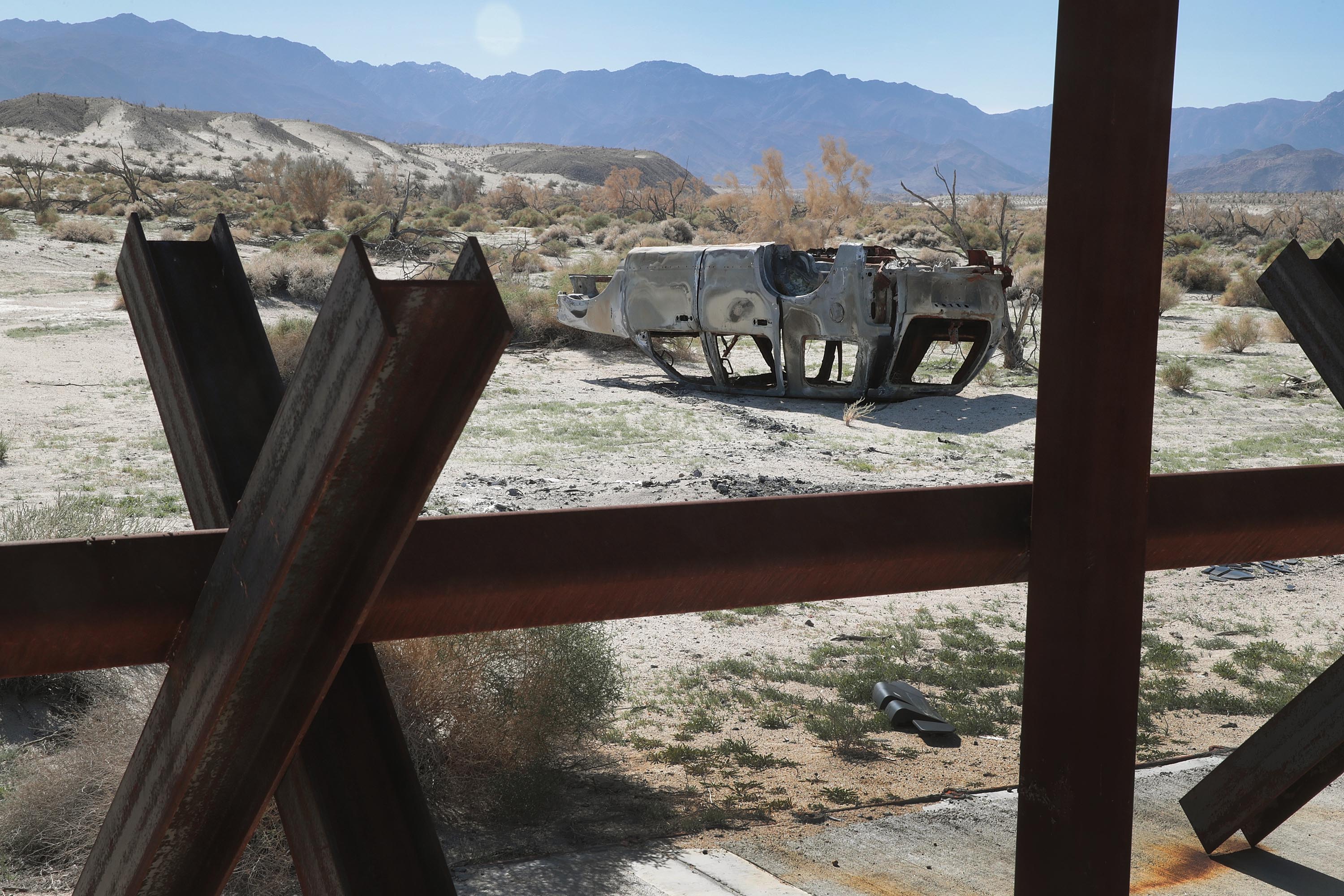 CALEXICO, CALIFORNIA - JANUARY 26: The remains of a vehicle rest on the ground near a barrier which runs along the border of the United States and Mexico on January 26, 2019 near Calexico, California. The U.S. government had been partially shut down as President Donald Trump battled congress for $5.7 billion in funding to resolve border security issues including building walls along the border. Yesterday, President Trump agreed to end the shutdown. (Photo by Scott Olson/Getty Images)