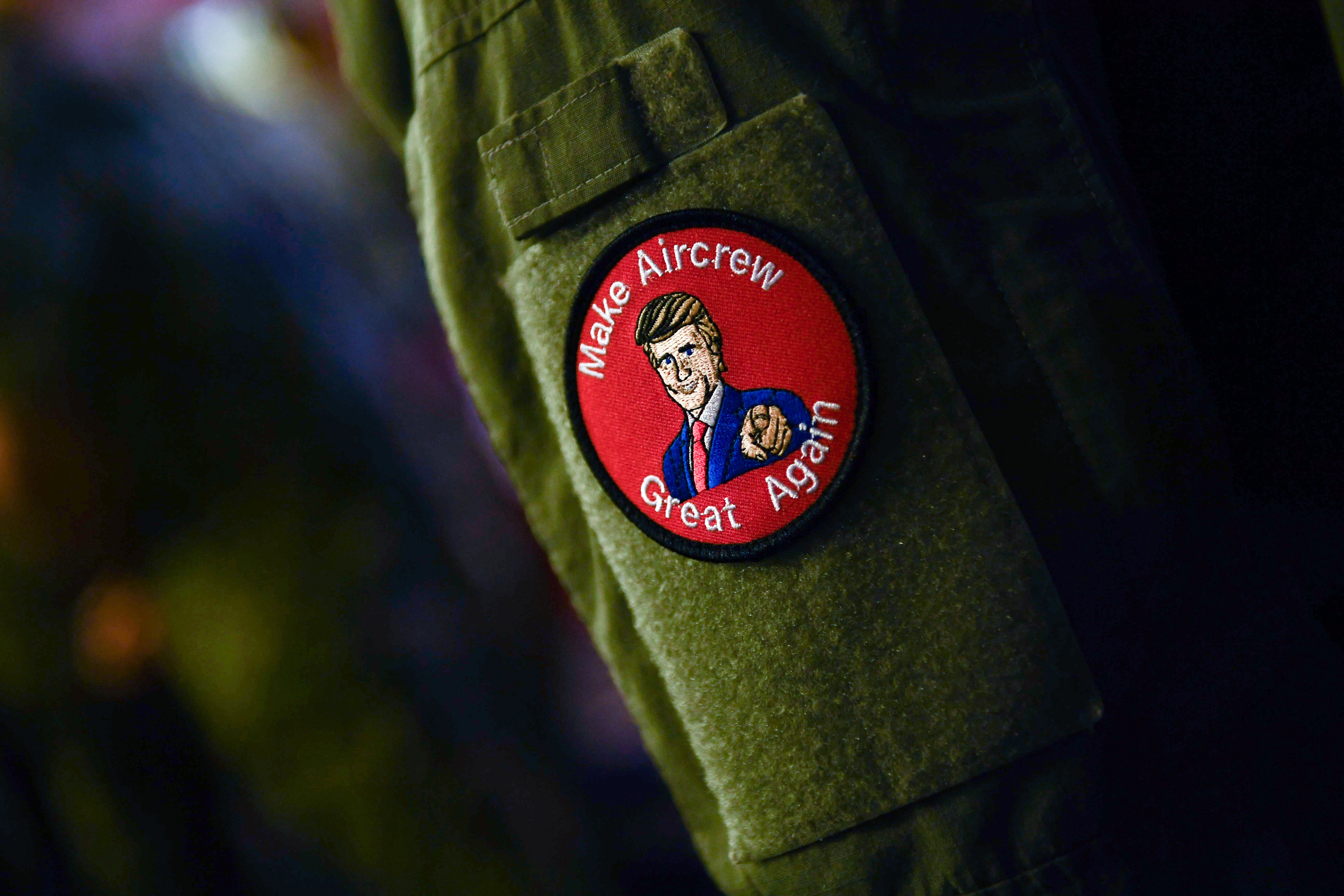 TOPSHOT - A US Marine wearing a badge listens to US President Donald Trump during a Memorial Day event aboard the amphibious assault ship USS Wasp (LHD 1) in Yokosuka on May 28, 2019. (Photo by BRENDAN SMIALOWSKI/AFP/Getty Images)
