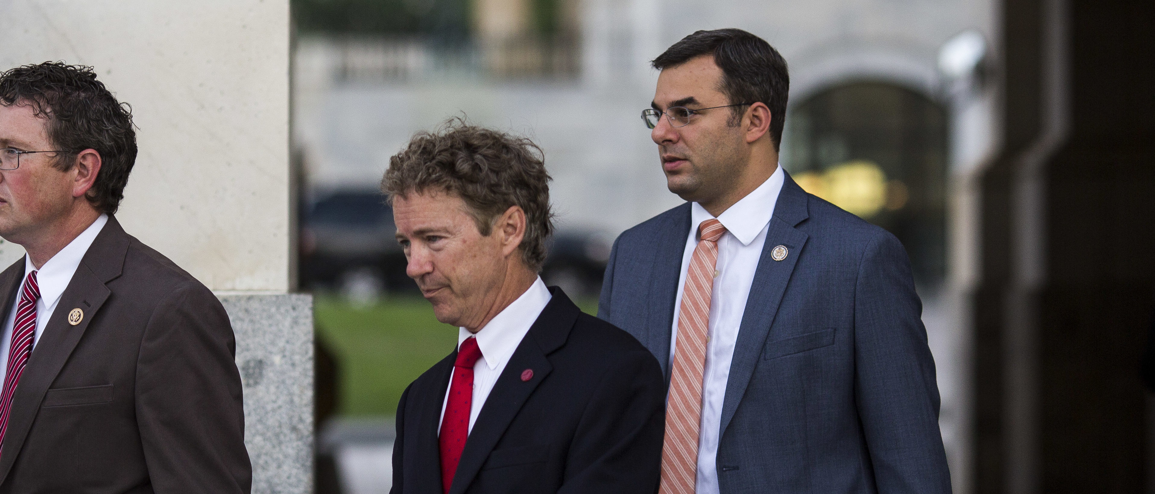 WASHINGTON, DC - MAY 31: (L - R) Rep. Thomas Massie (R-KY), Sen. Rand Paul (R-KY) and Rep. Justin Amash (R-MI) exit the Senate chamber after Paul spoke about surveillance legislation on the Senate floor, on Capitol Hill, May 31, 2015 in Washington, DC. The National Security Agency's authority to collect bulk telephone data is set to expire June 1, unless the Senate can come to an agreement to extend the surveillance programs. (Photo by Drew Angerer/Getty Images)