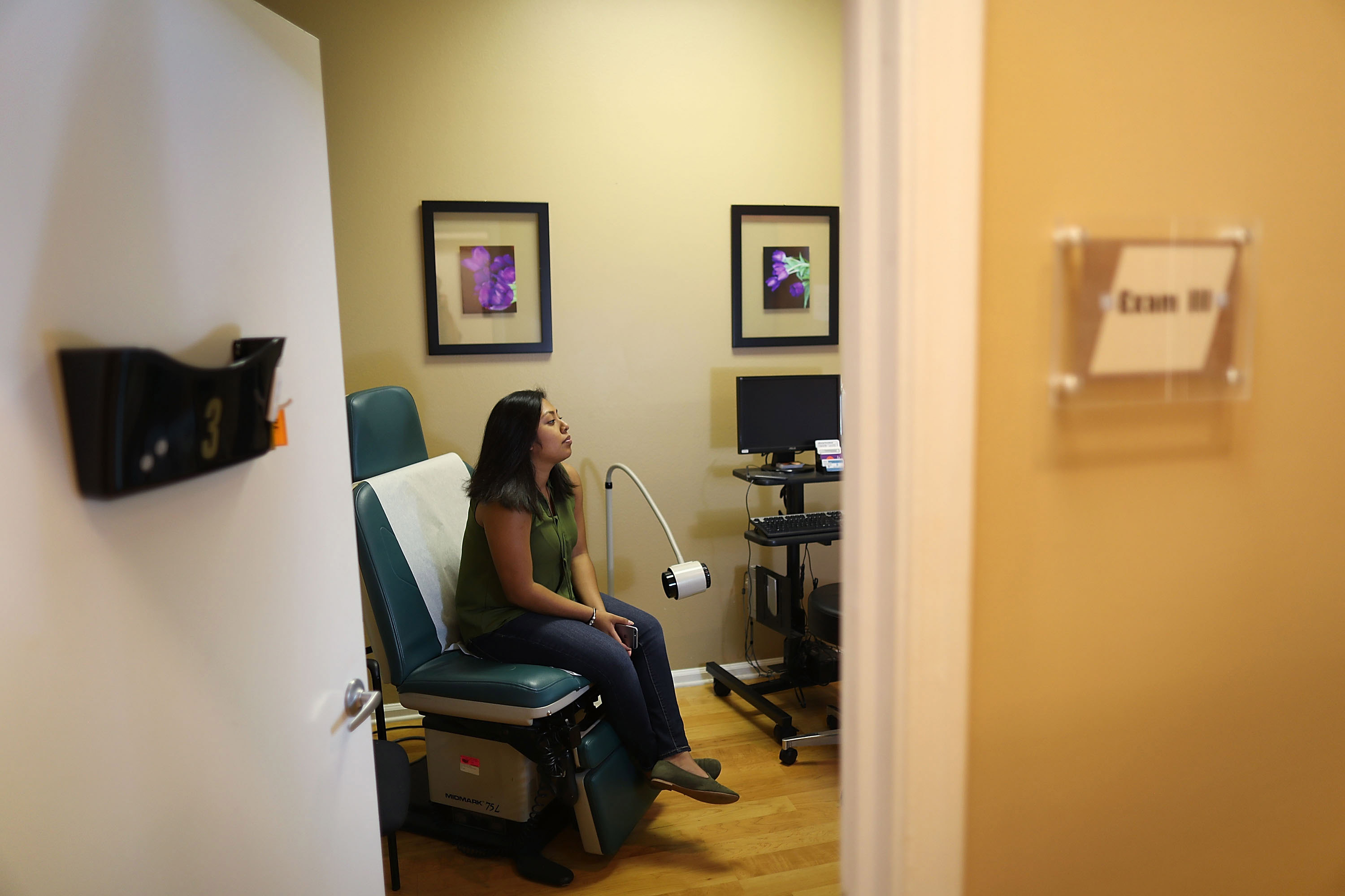 Natalia Reyes sits in the exam room as she gets a health care checkup at a Planned Parenthood health center ... (Photo by Joe Raedle/Getty Images)