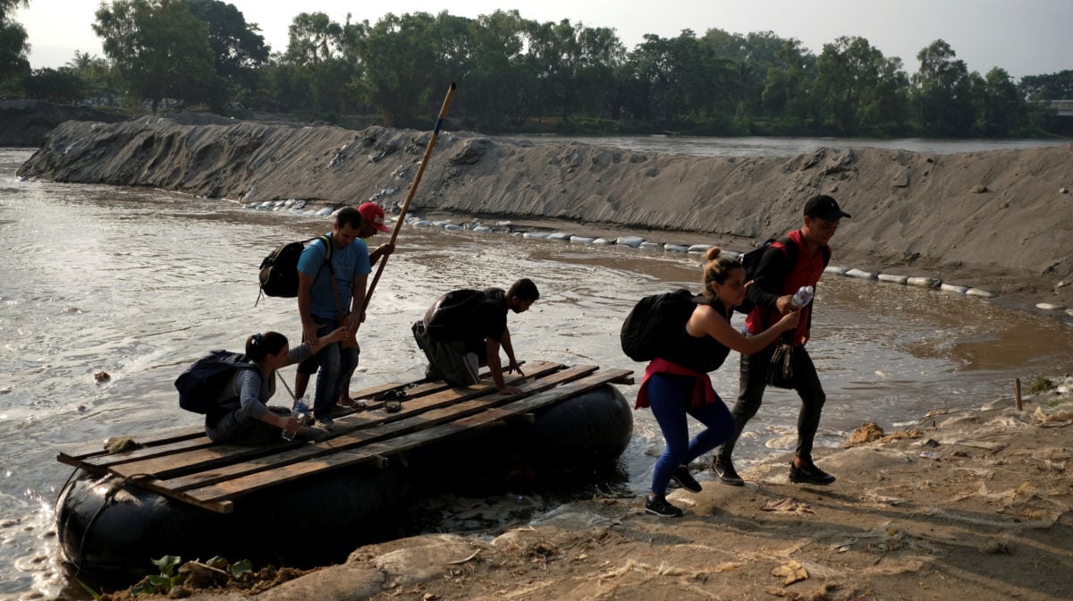 Migrants from Cuba en route to the United States, get off a raft as they crossed the Suchiate River from Tecun Uman, Guatemala to Ciudad Hidalgo