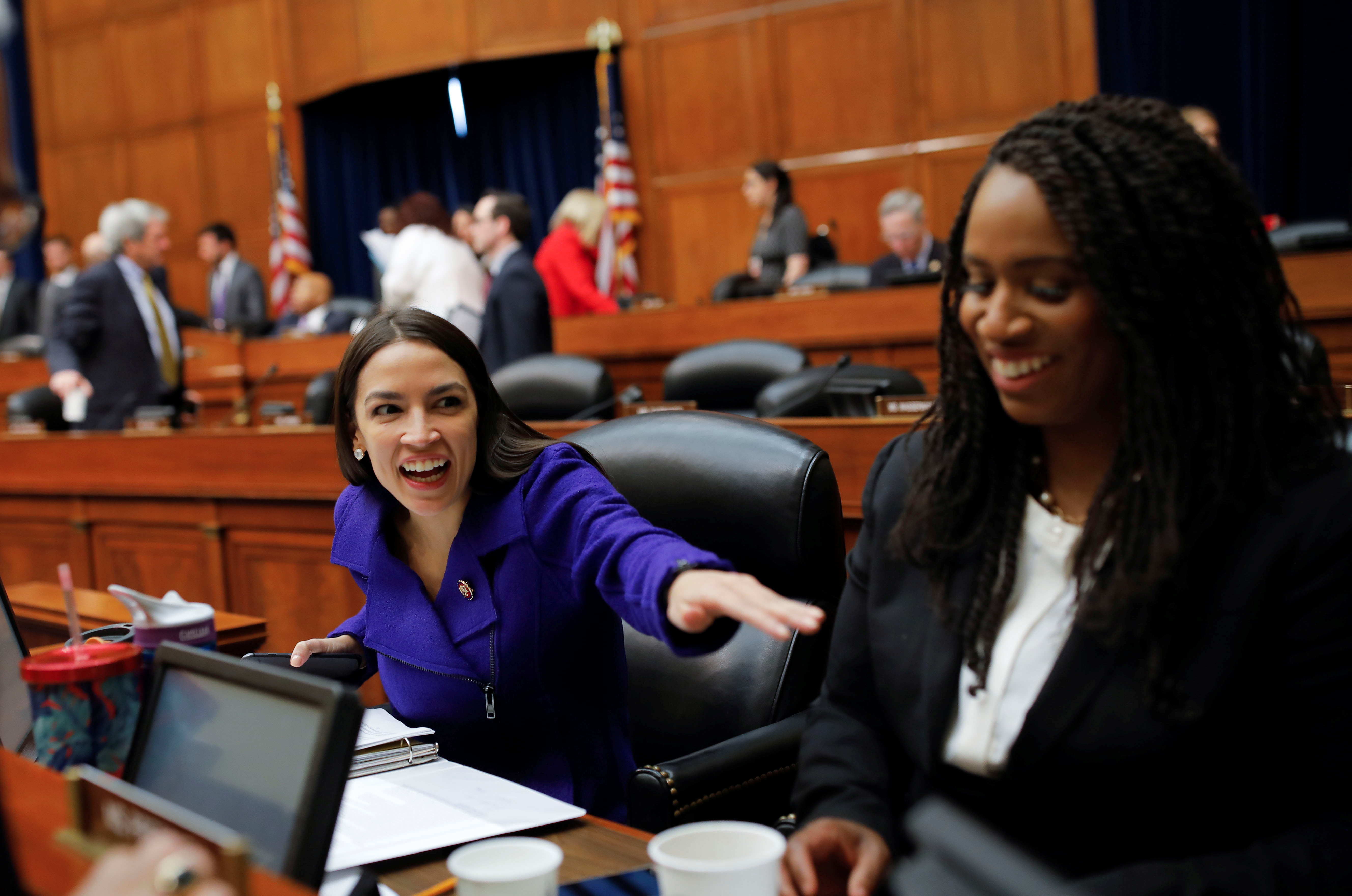 U.S. Rep. Alexandria Ocasio-Cortez laughs with Rep. Pressley after House Oversight and Reform Committee voted to subpeona White House about security clearances on Capitol Hill in Washington