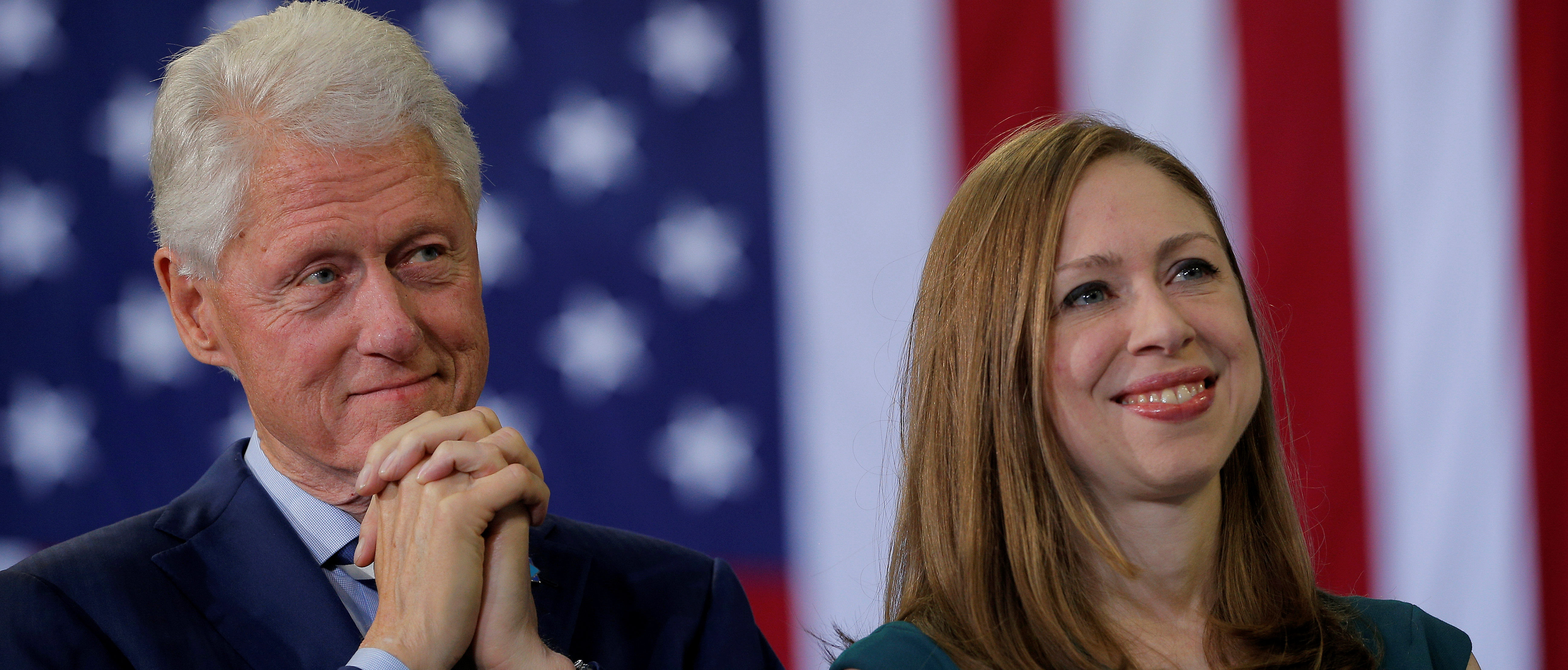Former U.S. President Bill Clinton and Chelsea Clinton listen as U.S. Democratic presidential nominee Hillary Clinton speaks at a campaign rally in Raleigh, North Carolina, U.S. November 8, 2016. REUTERS/Brian Snyder