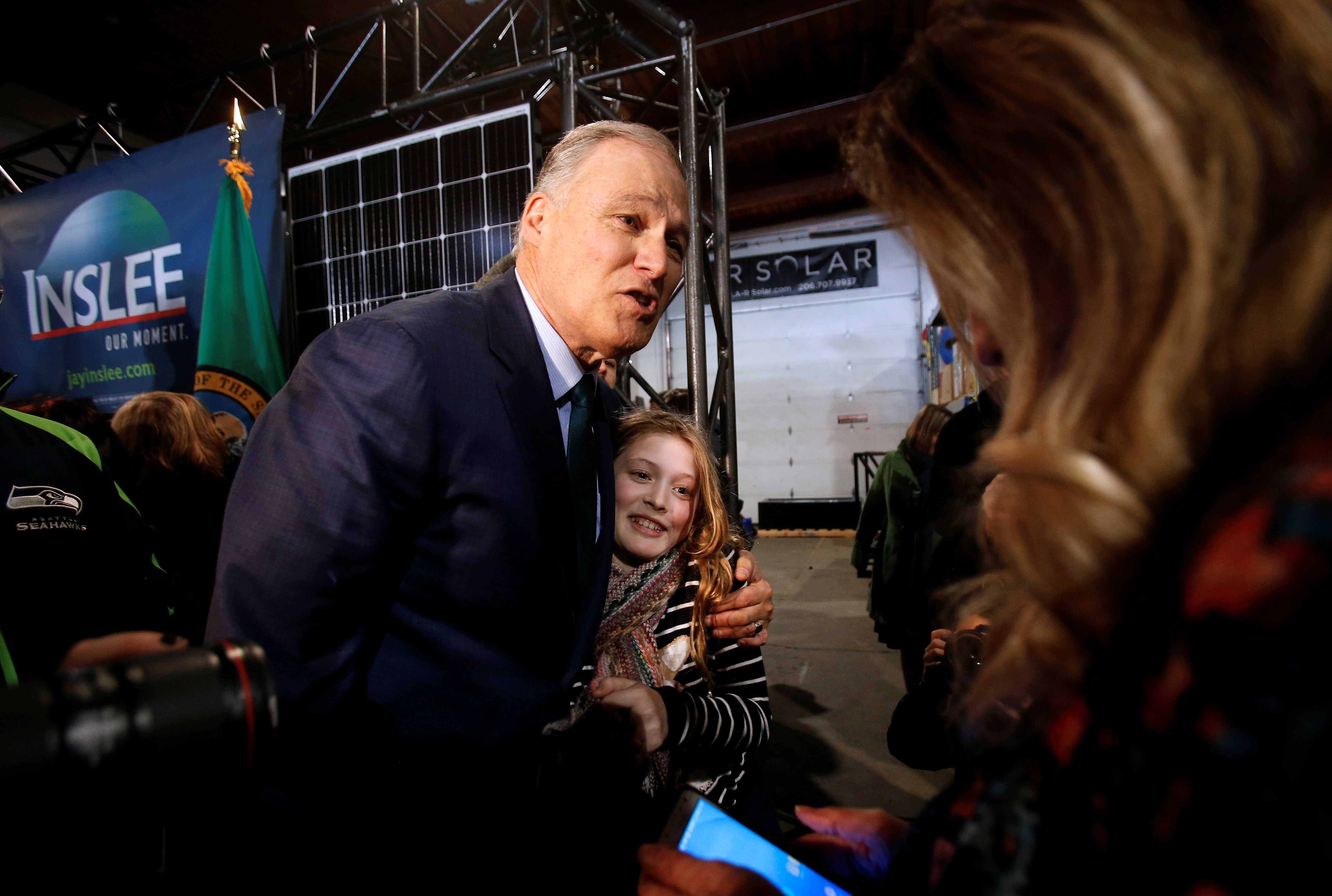 Washington state Governor Jay Inslee hugs Noreus, 11, of Redmond, Washington during a news conference to announce his decision to seek the Democratic Party's nomination for president in 2020 at A&R Solar in Seattle