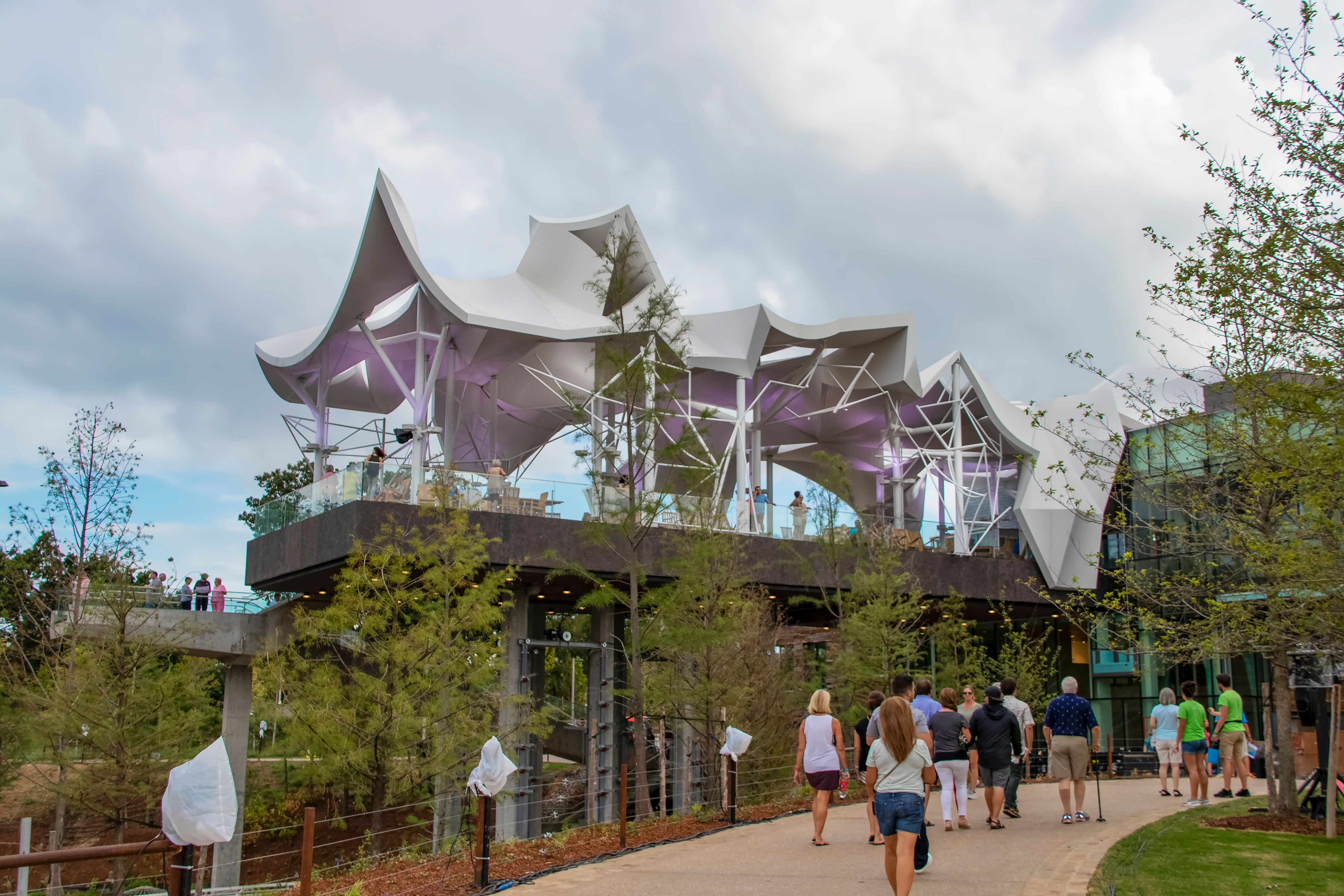Tulsa USA 9-4-2018 Sneak Peak of the Gathering Place - Unique community riverfront park - People up on the Boathouse deck and other people walking toward it - Photo by Shutterstock