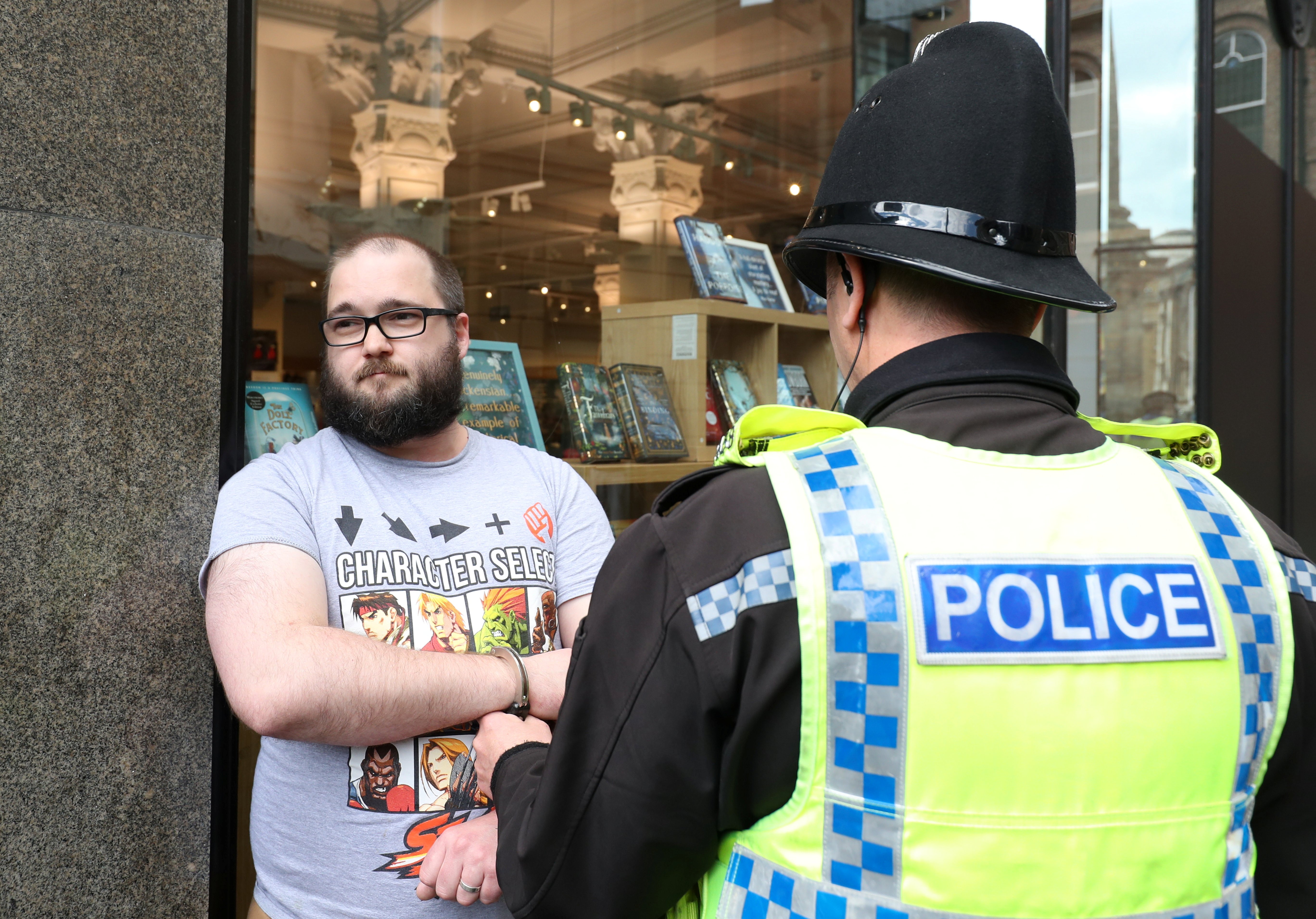 A man is detained by police after throwing a milkshake on Brexit Party leader Nigel Farage before a Brexit Party campaign event in Newcastle, Britain, May 20, 2019. REUTERS/Scott Heppell