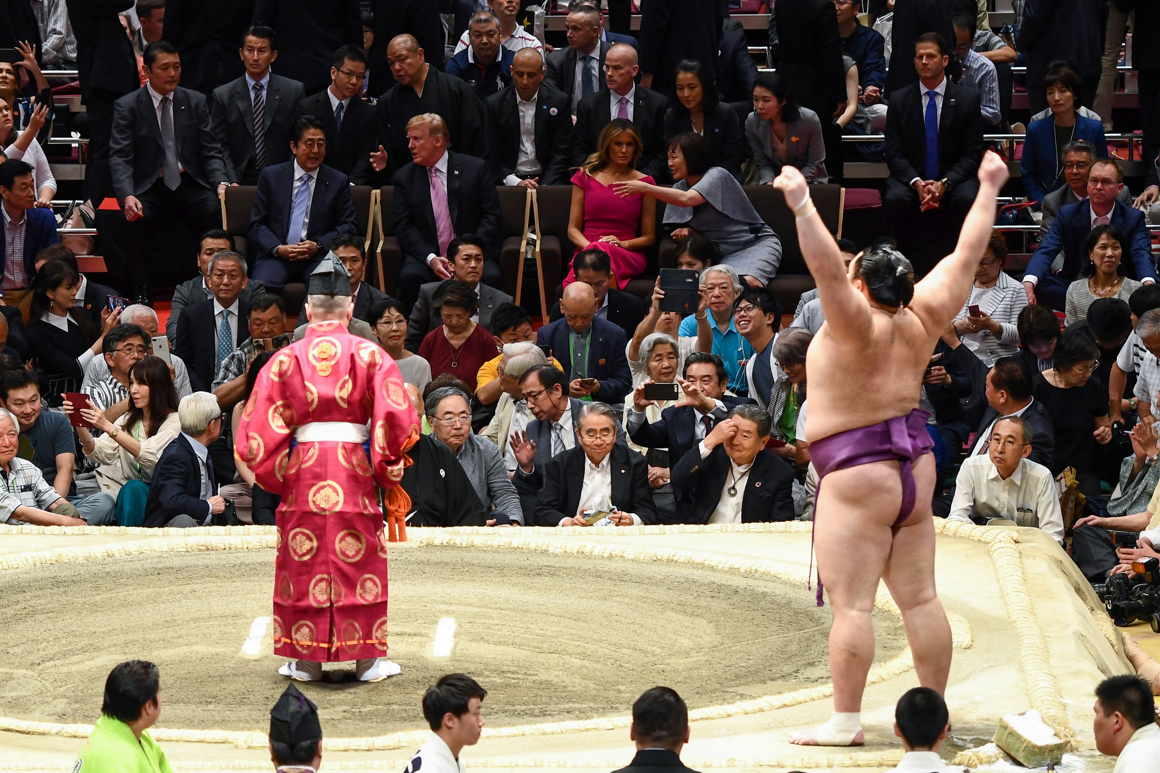 US President Donald Trump and First Lady Melania Trump are accompanied by Japan's Prime Minister Shinzo Abe and his wife Akie Abe (centre row) as they watch a sumo battle during the Summer Grand Sumo Tournament in Tokyo on May 26, 2019. BRENDAN SMIALOWSKI/AFP/Getty Images