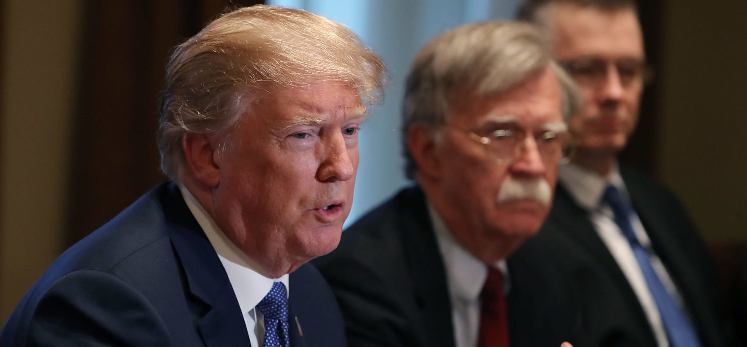 U.S. President Donald Trump is flanked by National Security Advisor John Bolton as he speaks about the FBI raid at his lawyer Michael Cohen's office, while receiving a briefing from senior military leaders regarding Syria, in the Cabinet Room, on April 9, 2018 in Washington, DC. The FBI raided the office of Michael Cohen on Monday as part of the ongoing investigation into the president's administration. Mark Wilson/Getty Images