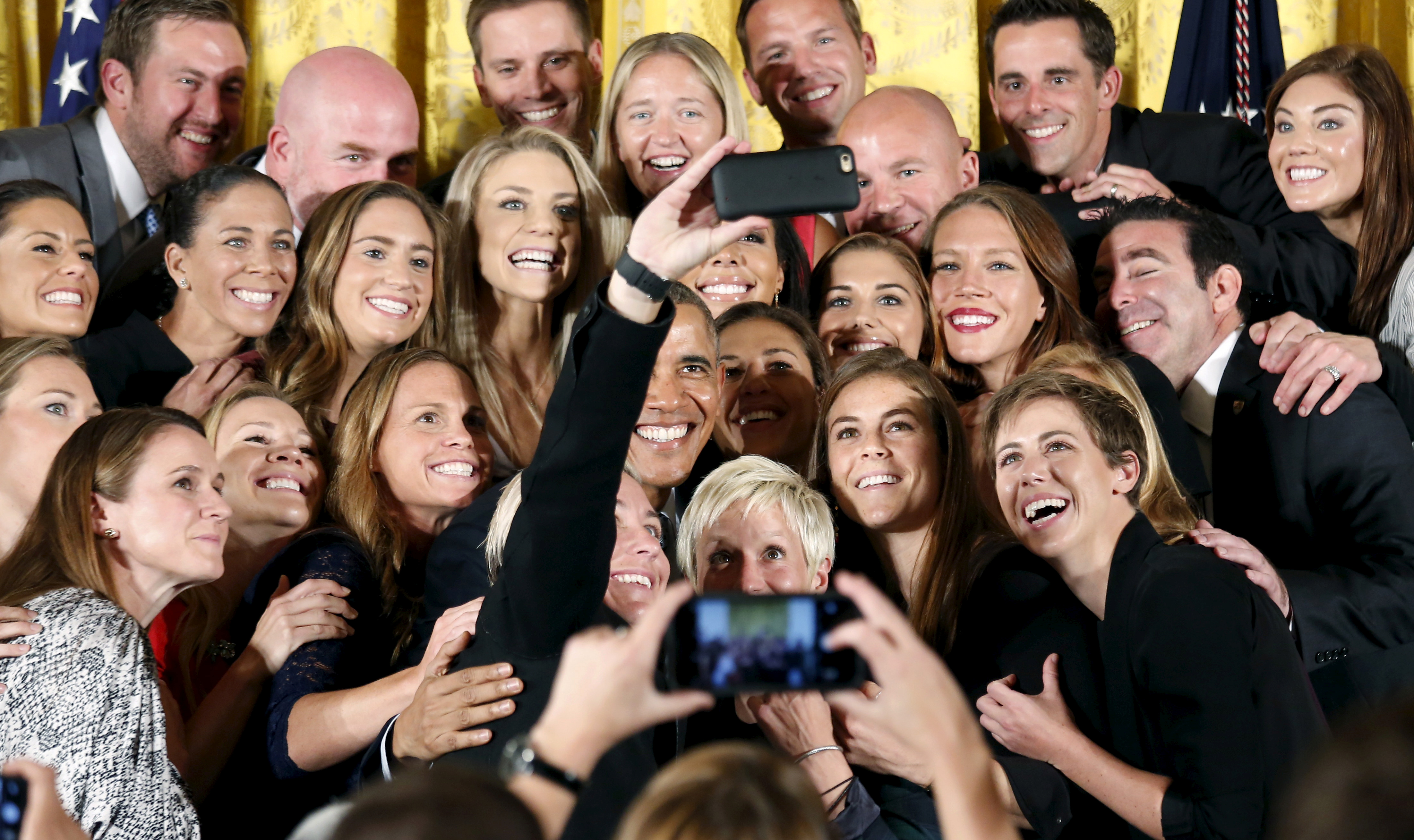 FILE PHOTO: U.S. President Barack Obama poses for a selfie taken by veteran star player Abby Wambach during an event honoring the United States Women's National Soccer Team's victory in the 2015 FIFA Women's World Cup at the White House in Washington October 27, 2015. REUTERS/Kevin Lamarque/File Photo 
