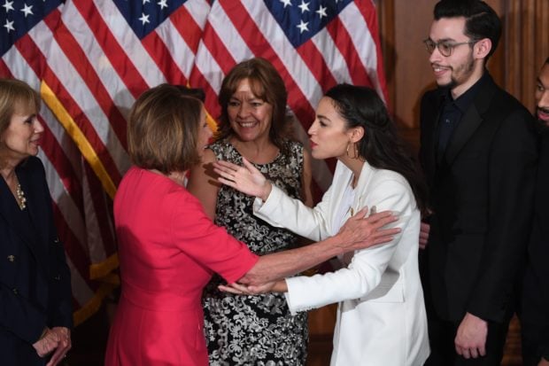 Speaker of the House Nancy Pelosi (L) greets Rep. Alexandria Ocasio-Cortez (R), D-NY, during the ceremonial swearing-in at the start of the 116th Congress at the US Capitol in Washington, DC, January 3, 2019. (Photo by SAUL LOEB / AFP / GETTY)