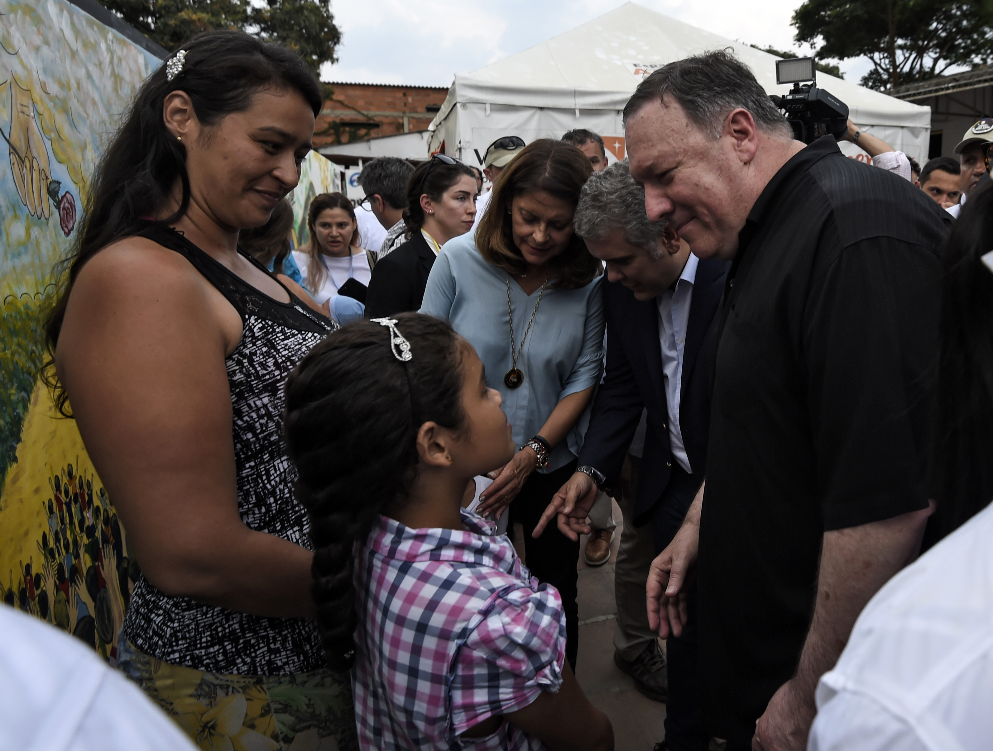 US Secretary of State Mike Pompeo (R), accompanied by Colombian President Ivan Duque (2-R) talks with Venezuelan refugees during a visit to the Transitional Attention for the Migrant Office in Cucuta, Norte del Santander Department, Colombia, on the border with Venezuela, on April 14, 2019. (JUAN BARRETO/AFP/Getty Images)