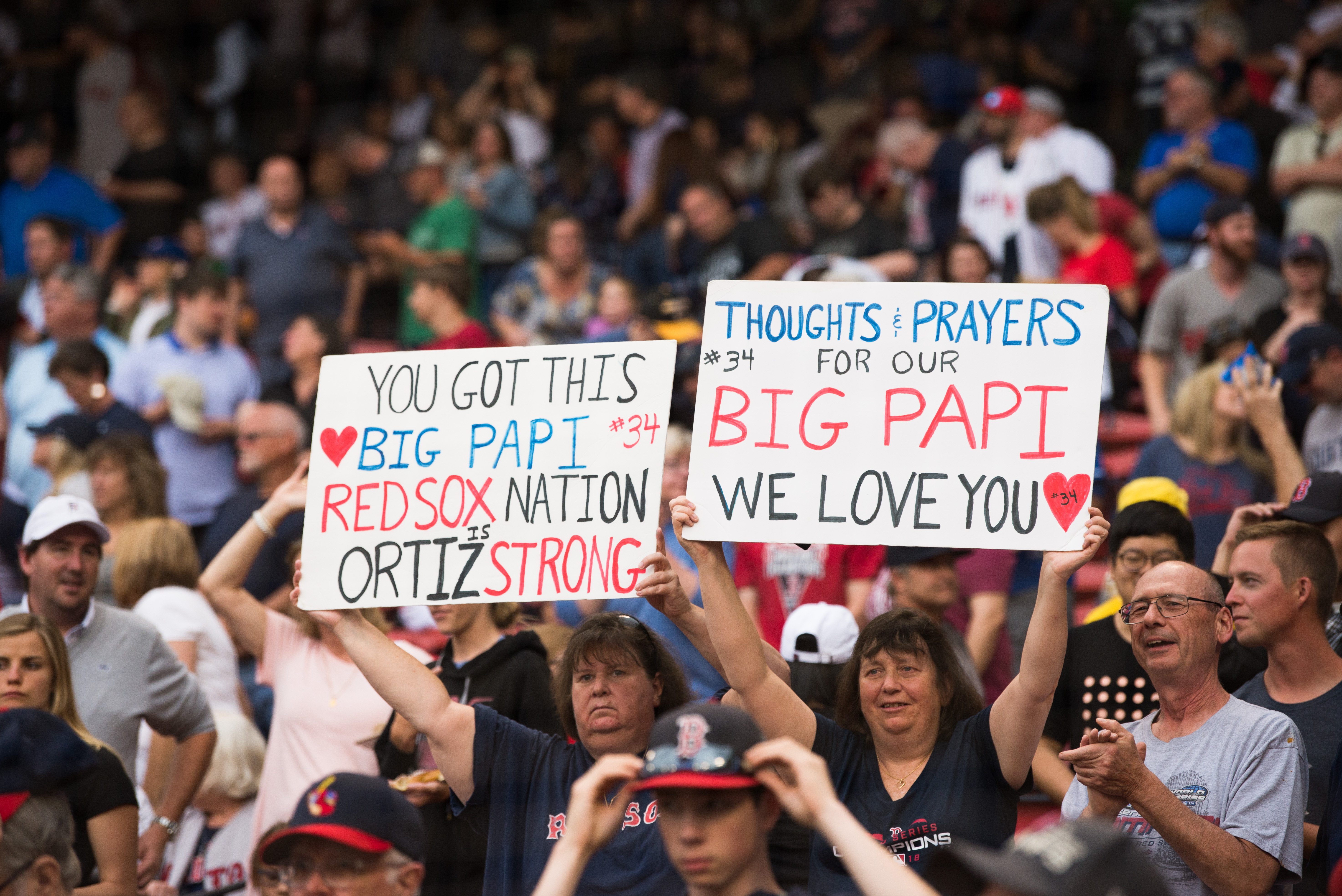 Fans hold up signs showing support for former Red Sox player David Ortiz prior to the start of the game against the Texas Rangers at Fenway Park on June 10, 2019 in Boston, Massachusetts. (Photo by Kathryn Riley /Getty Images)