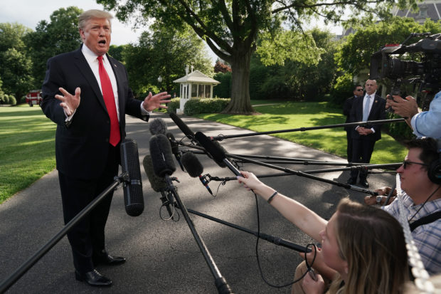 WASHINGTON, DC - MAY 20: U.S. President Donald Trump talks to journalists as he departs the White House for a campaign rally in Pennsylvania May 20, 2019 in Washington, DC. On his way to Montoursville, Pennsylvania, Trump said that Iran does not currently pose a direct threat to the United States. (Photo by Chip Somodevilla/Getty Images)