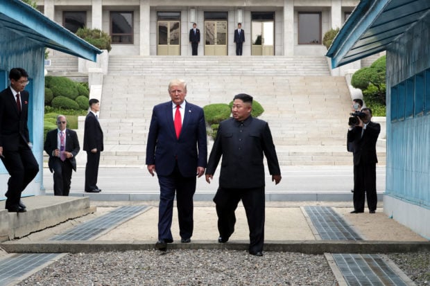 PANMUNJOM, SOUTH KOREA - JUNE 30: A handout photo provided by Dong-A Ilbo of North Korean leader Kim Jong Un and U.S. President Donald Trump inside the demilitarized zone (DMZ) separating the South and North Korea on June 30, 2019 in Panmunjom, South Korea. U.S. President Donald Trump and North Korean leader Kim Jong-un briefly met at the Korean demilitarized zone (DMZ) on Sunday, with an intention to revitalize stalled nuclear talks and demonstrate the friendship between both countries. The encounter was the third time Trump and Kim have gotten together in person as both leaders have said they are committed to the "complete denuclearization" of the Korean peninsula. (Photo by Handout/Dong-A Ilbo via Getty Images)