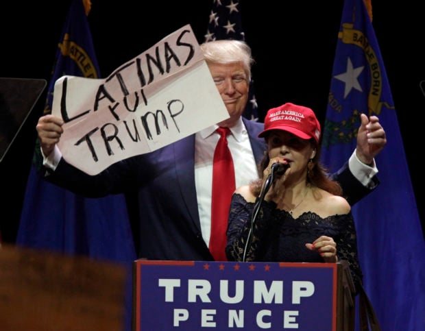 A Latino supporter speaks on stage with Republican presidential candidate Donald Trump during a campaign rally at the Venetian Hotel on October 30, 2016 in Las Vegas, Nevada. (JOHN GURZINSKI/AFP/Getty Images)