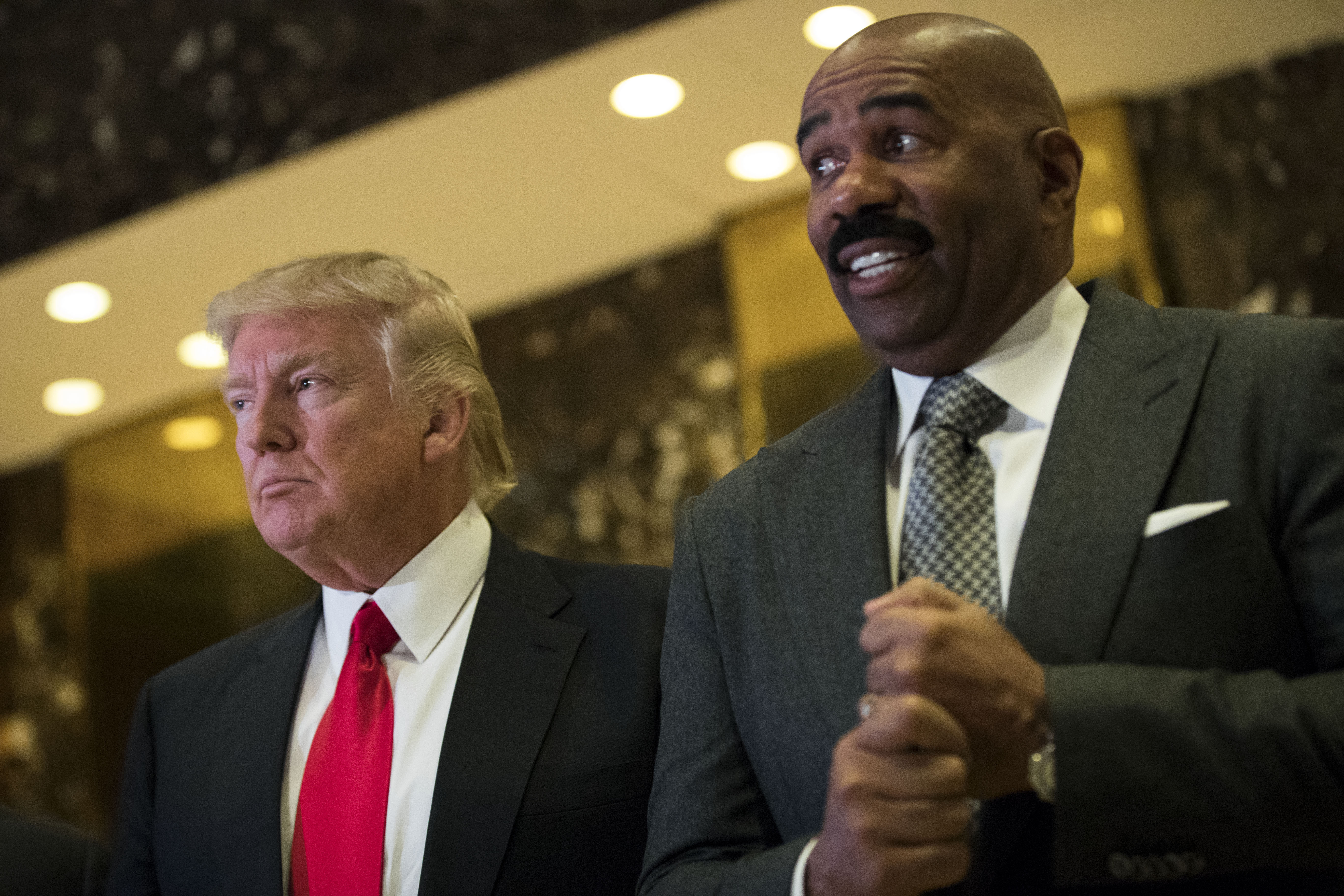 President-elect Donald Trump and television personality Steve Harvey speak to reporters after their meeting at Trump Tower, January 13, 2017 in New York City. President-elect Trump continues to hold meetings at Trump Tower in New York. (Photo by Drew Angerer/Getty Images)