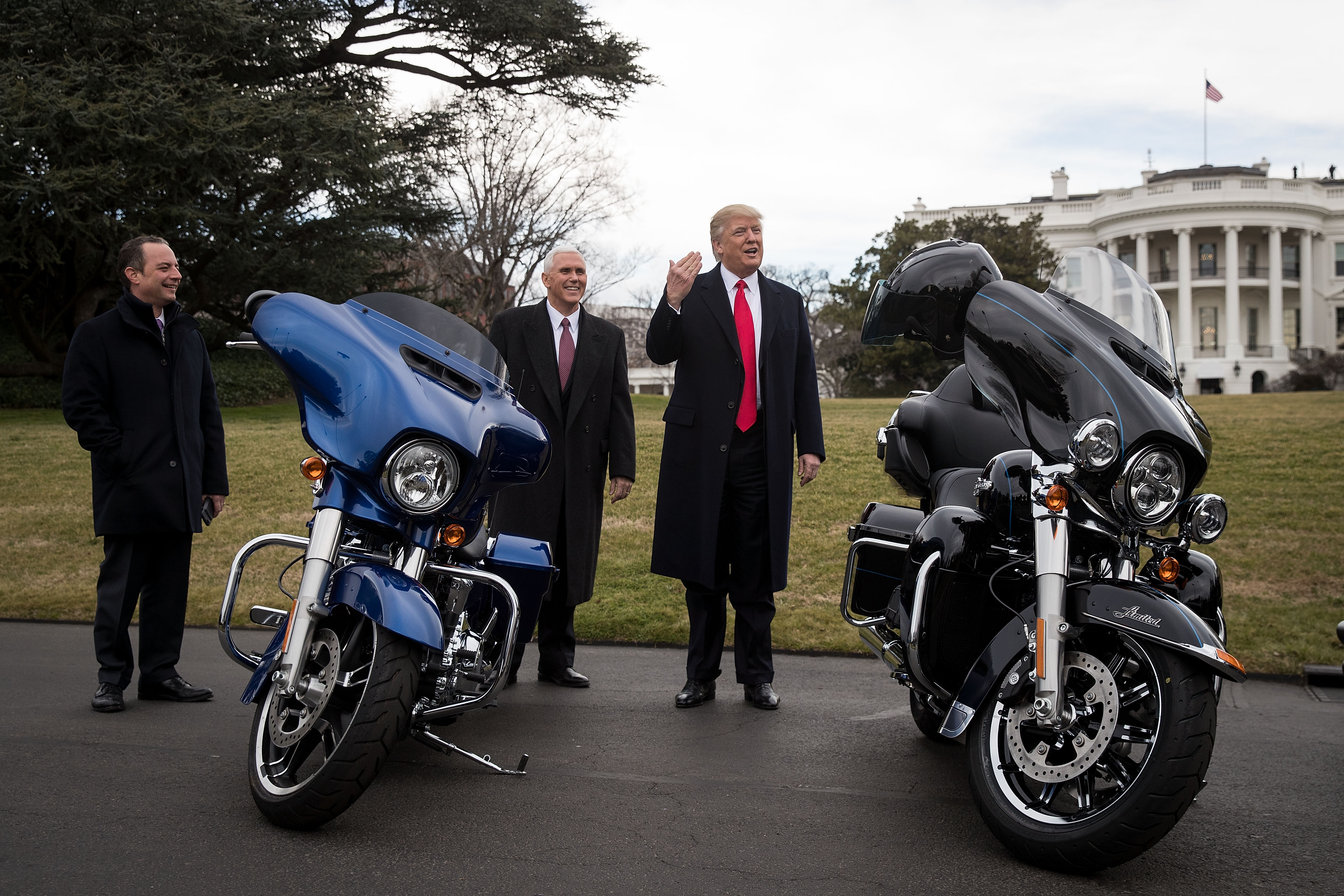 White House Chief of Staff Reince Priebus and Vice President Mike Pence look on as President Donald Trump speaks briefly to reporters after greeting Harley Davidson executives on the South Lawn of the White House, February 2, 2017 in Washington, DC. (Photo by Drew Angerer/Getty Images)