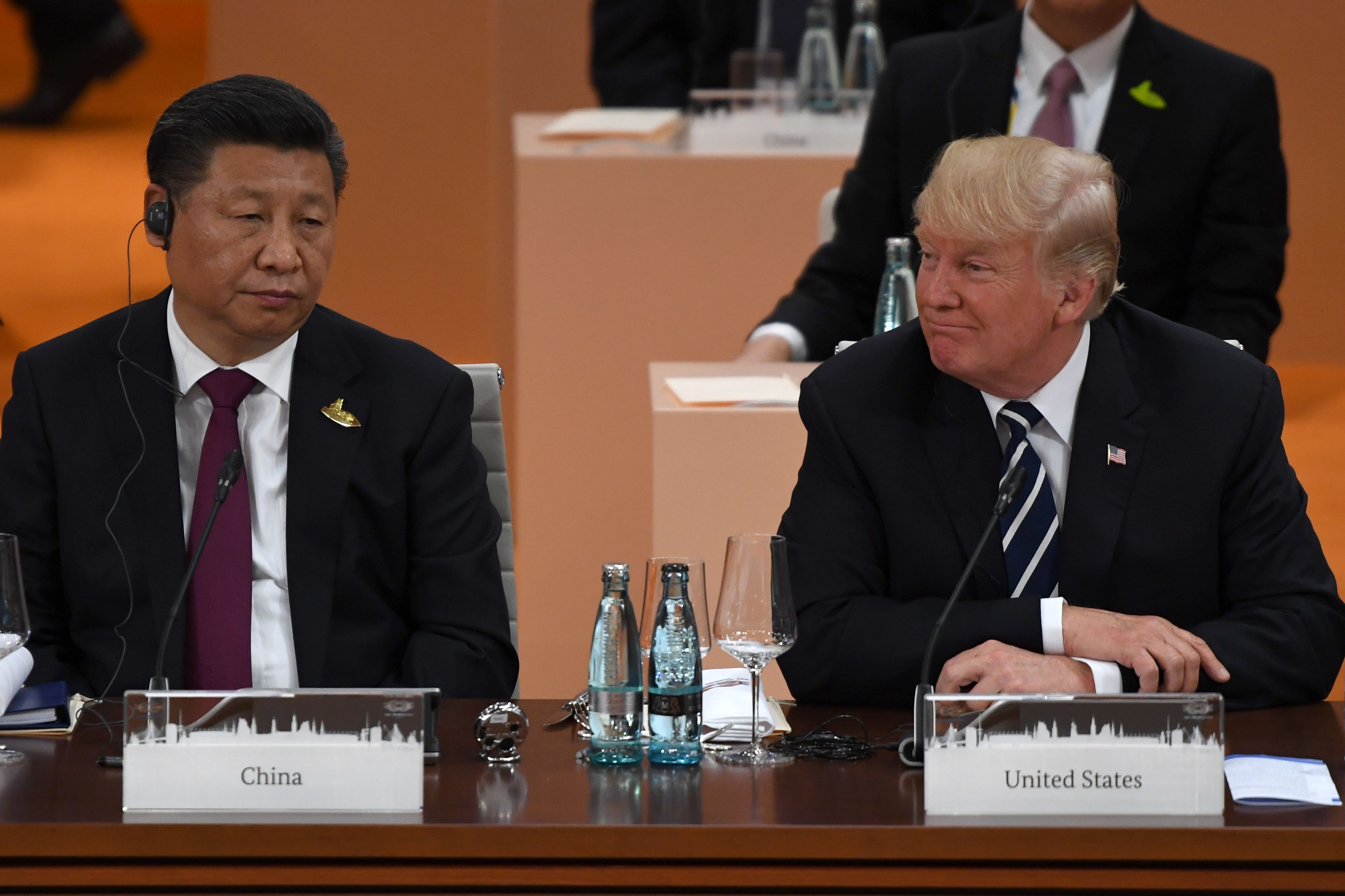 China's President Xi Jinping (L) and US President Donald Trump attend a working session on the first day of the G20 summit in Hamburg, northern Germany, on July 7, 2017. Leaders of the world's top economies gather from July 7 to 8, 2017 in Germany for likely the stormiest G20 summit in years, with disagreements ranging from wars to climate change and global trade. / AFP PHOTO / Patrik STOLLARZ (Photo credit should read PATRIK STOLLARZ/AFP/Getty Images)