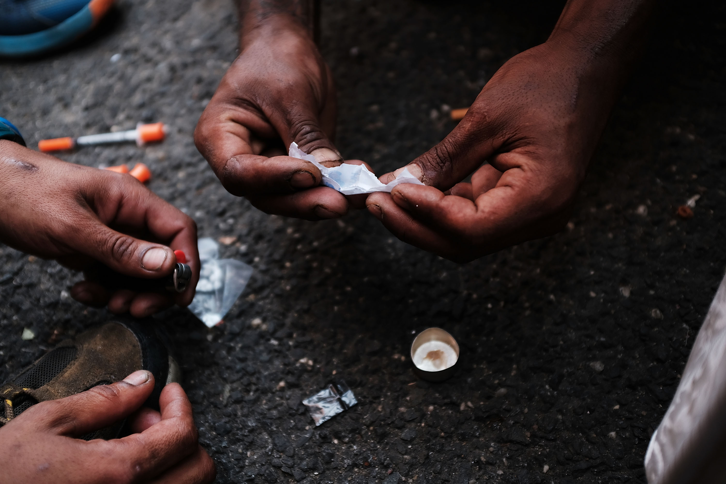 Heroin users prepare to shoot up on the street in a South Bronx neighborhood which has the highest rate of heroin-involved overdose deaths in the city (Spencer Platt/Getty Images)