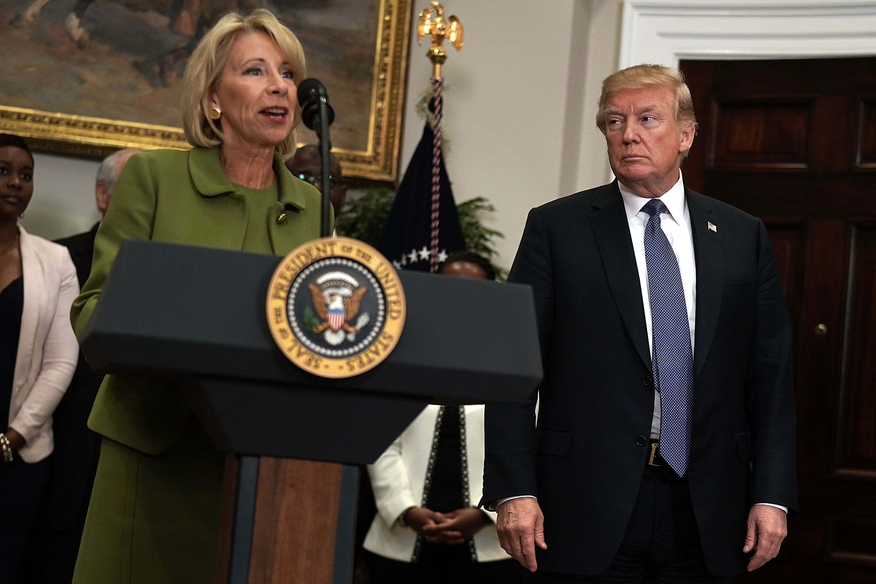 U.S. Secretary of Education Betsy DeVos (L) speaks as President Donald Trump (R) listens during an announcement in the Roosevelt Room of the White House February 27, 2018 in Washington, DC. President Trump announced that Taylor will become the new chairman and chairman of the Board of Advisors on the White House Initiative on Historically Black Colleges and Universities. (Photo by Alex Wong/Getty Images)