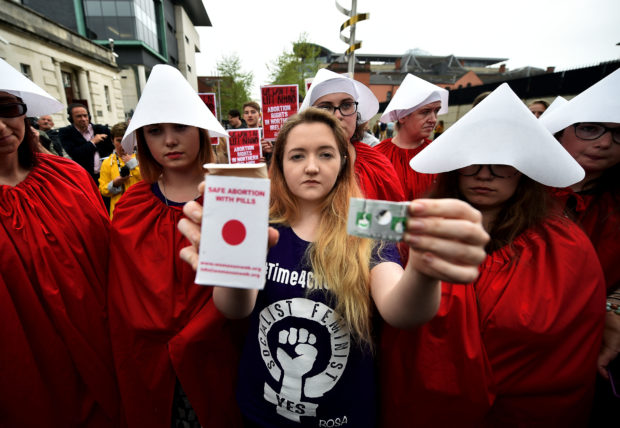 Eleanor Crossey Malone displays an abortion pill packet after taking a pill as abortion rights campaign group ROSA, Reproductive Rights Against Oppression, Sexism and Austerity distribute abortion pills from a touring bus on May 31, 2018 in Belfast, Northern Ireland. Flouting Northern Irish governmental laws which forbid the use of abortion pills the group are also protesting outside offices belonging to the main political parties in the province.(Charles McQuillan/Getty Images)