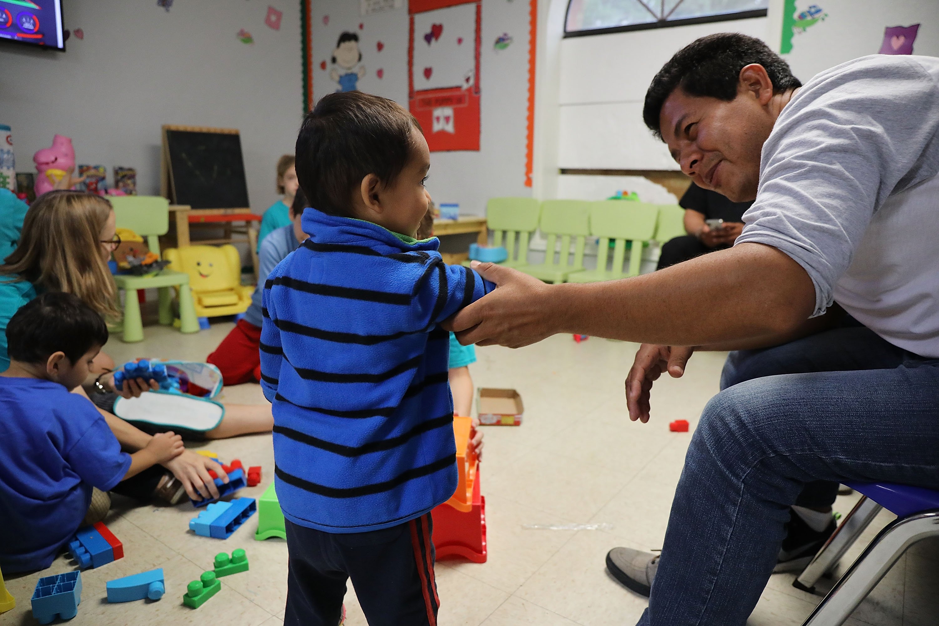 MCALLEN, TX - JUNE 21: Recently arrived migrant families rest at the Catholic Charities Humanitarian Respite Center on June 21, 2018 in McAllen, Texas. Once families and individuals are released from Customs and Border Protection to continue their legal process, they are brought to the center to rest, clean up, enjoy a meal and get guidance to their next destination. Before Trump signed an executive order yesterday that the administration says halts the practice of separating families seeking asylum, more than 2,300 immigrant children had been separated from their parents in the zero-tolerance policy for border crossers. (Photo by Spencer Platt/Getty Images)