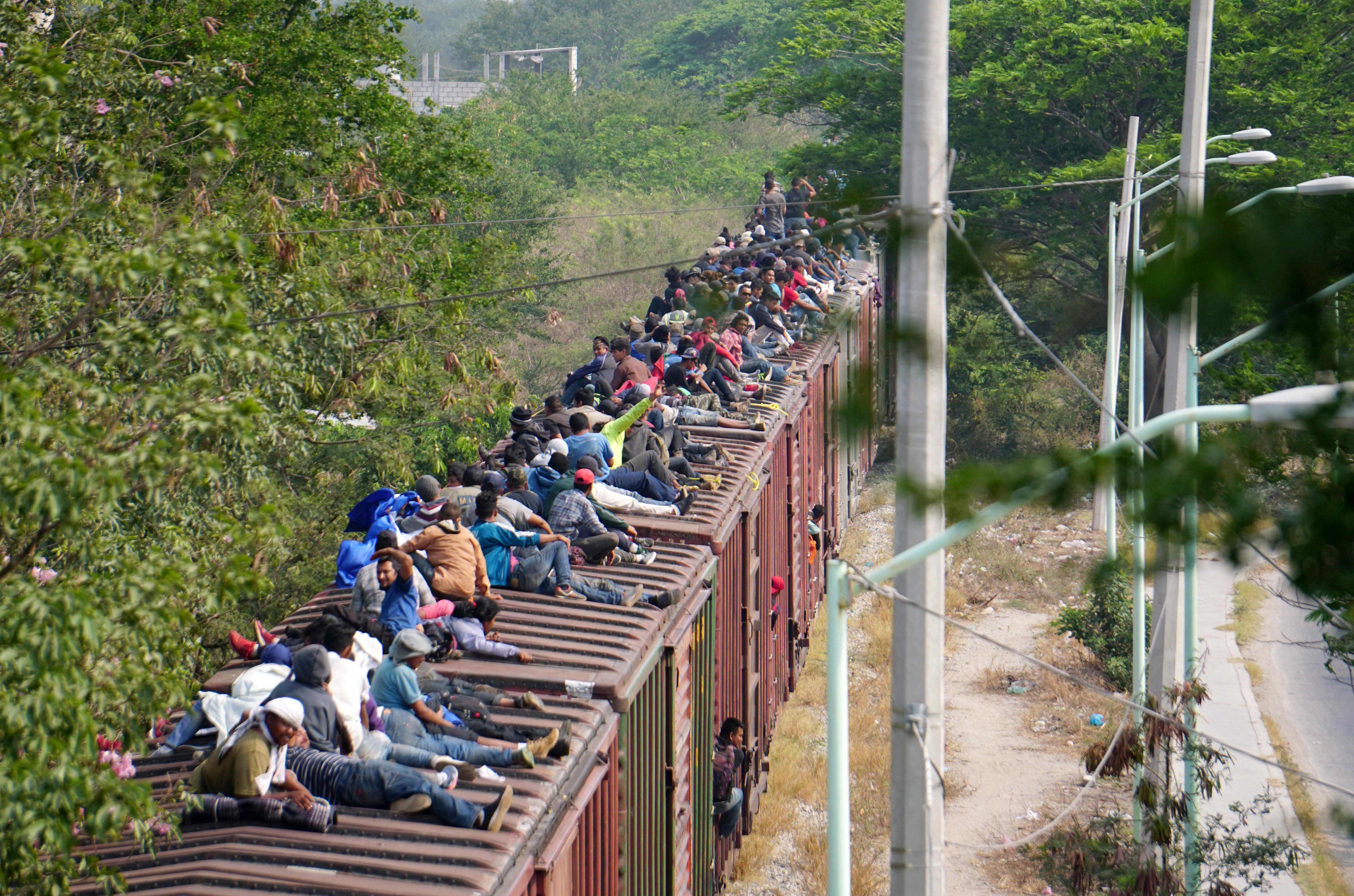 FILE PHOTO: Central American migrants ride train through Juchitan, Oaxaca