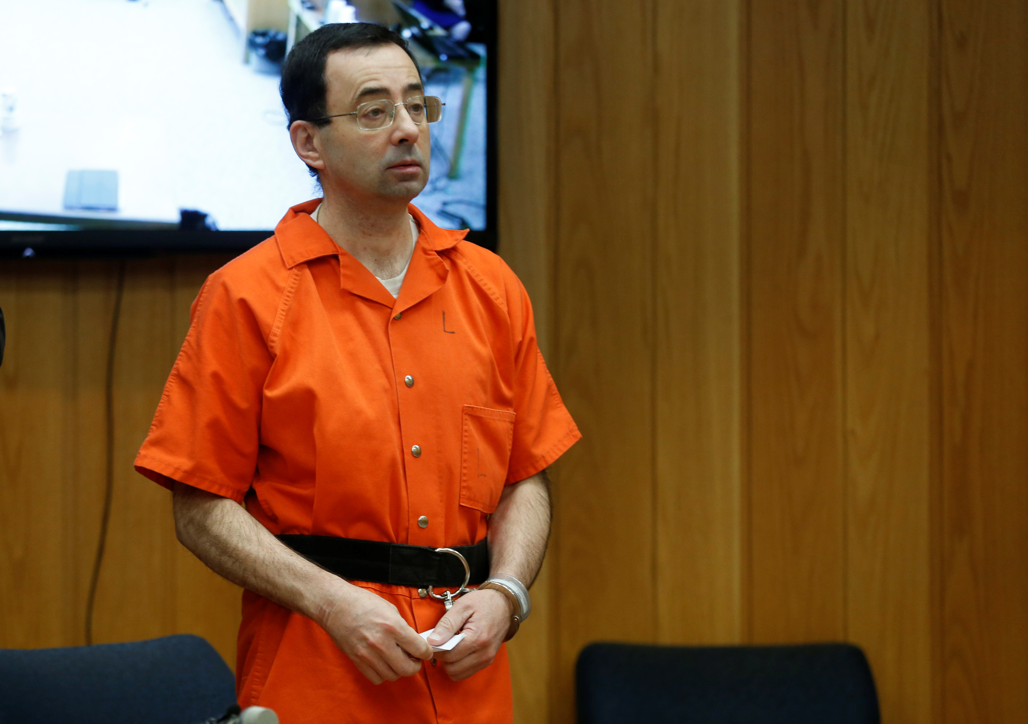 Larry Nassar, a former team USA Gymnastics doctor who pleaded guilty in November 2017 to sexual assault charges, stands in court during his sentencing hearing in the Eaton County Court in Charlotte, Michigan, U.S., February 5, 2018. REUTERS/Rebecca Cook