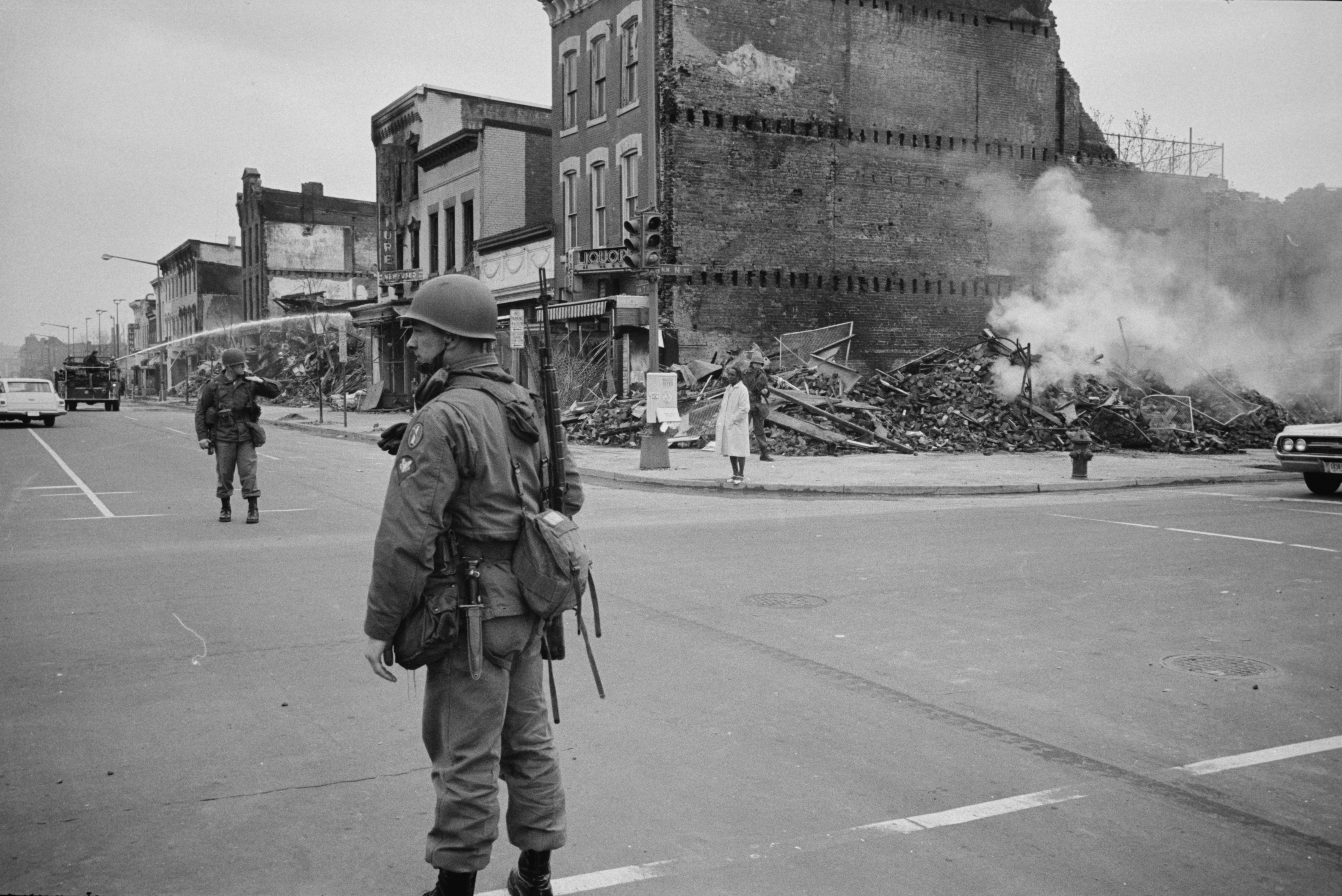 A soldier standing guard with the ruins of buildings that were destroyed during the riots that followed the assassination of Martin Luther King, Jr., in this April 8, 1968 photograph (Library of Congress/Handout via Reuters/Reuters)