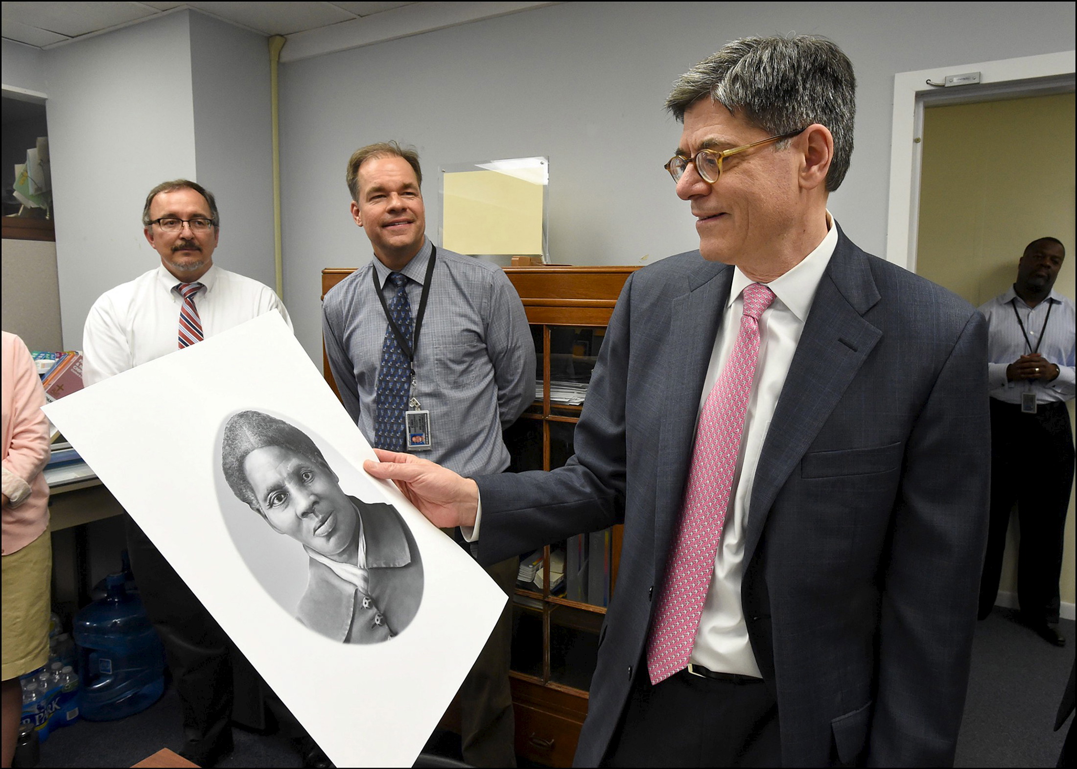 U.S. Secretary Jack Lew (R) looks at a rendering of Harriet Tubman during a visit to the Bureau of Engraving and Printing in Washington, U.S., in this handout photograph taken on April 21, 2016 and released on April 22. The visit follows Treasury's decision to replace former President Andrew Jackson with Tubman on the U.S. $20 bill, and put leaders of the women's suffrage movement on the back of $10 bill. Picture taken April 21, 2016. Department of Treasury/Chris Taylor/Handout via Reuters 
