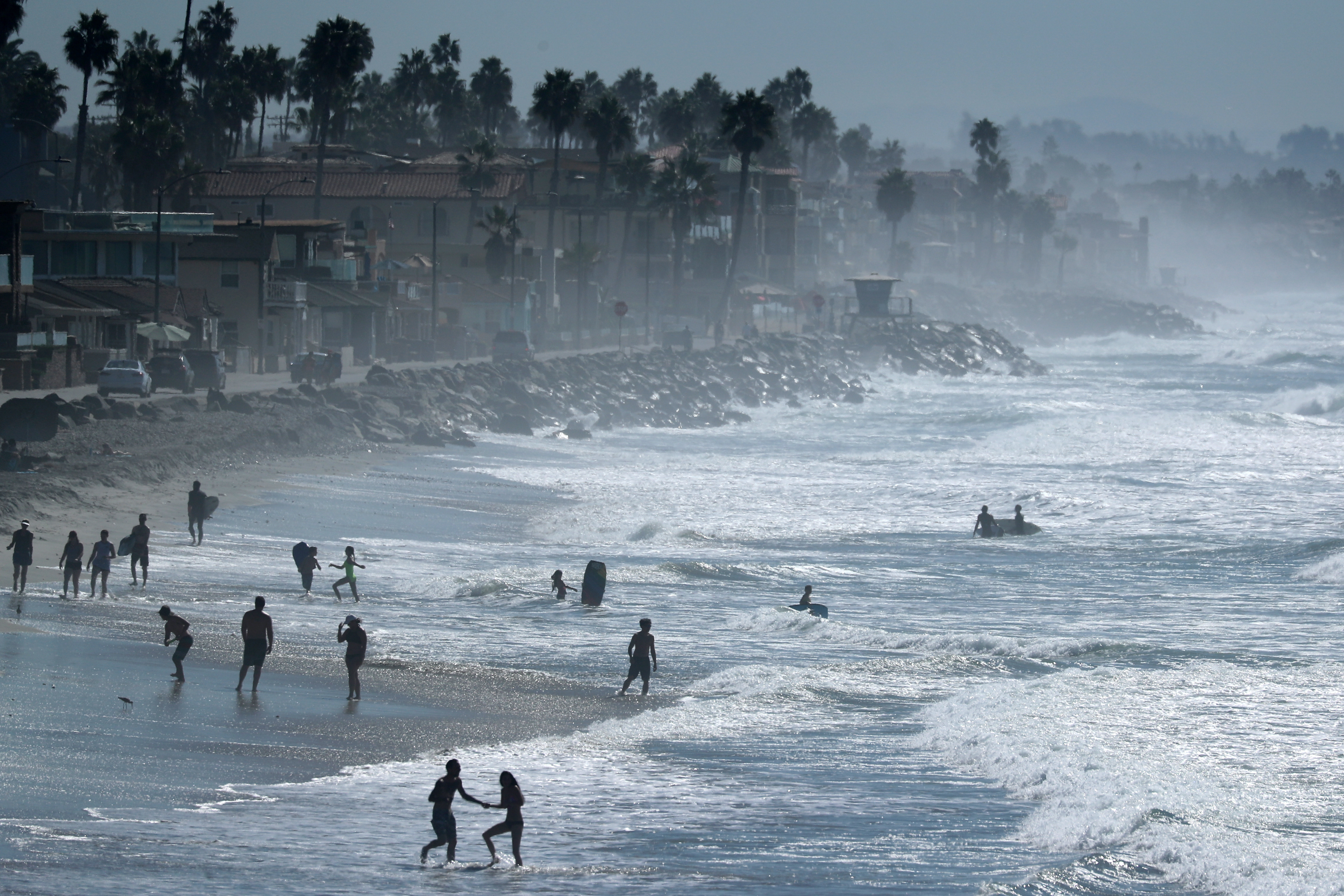 People cool off at the beach during a Southern California heat wave in Oceanside, California