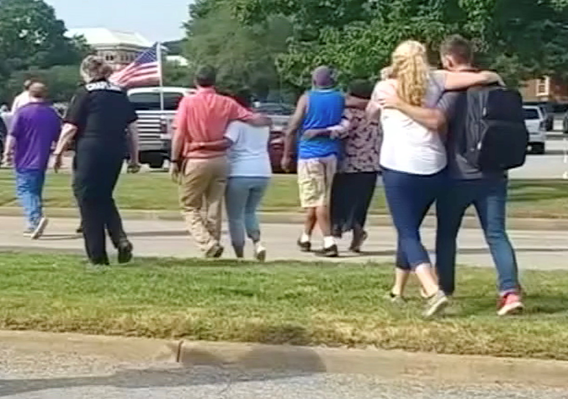 Evacuees walk away from a building in this still image taken from video following a shooting incident at the municipal center in Virginia Beach, Virginia, U.S. May 31, 2019. WAVY-TV/NBC/via REUTERS