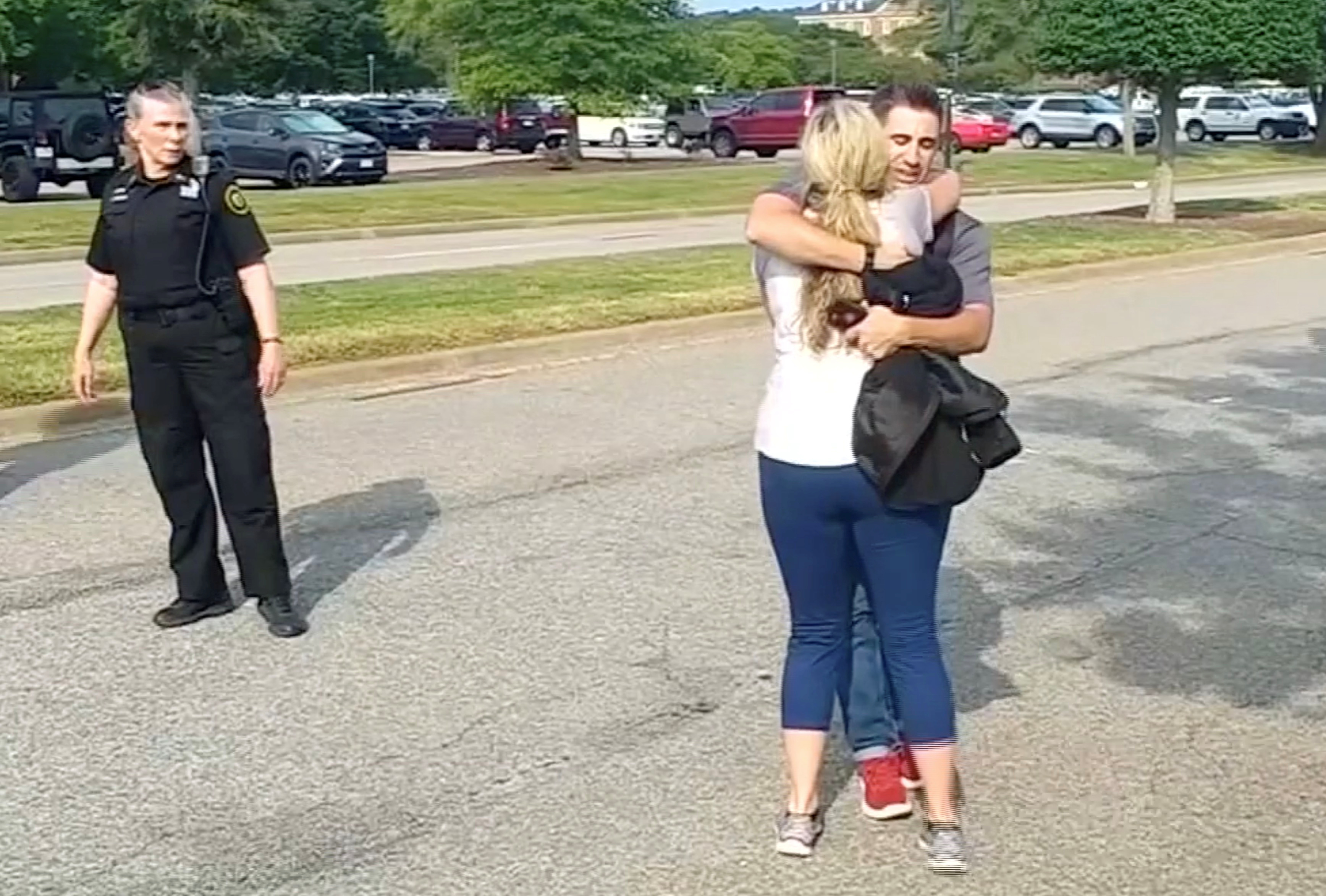 People embrace after being evacuated from a building by police in this still image taken from video following a shooting incident at the municipal center in Virginia Beach, Virginia, U.S. May 31, 2019. WAVY-TV/NBC/via REUTERS